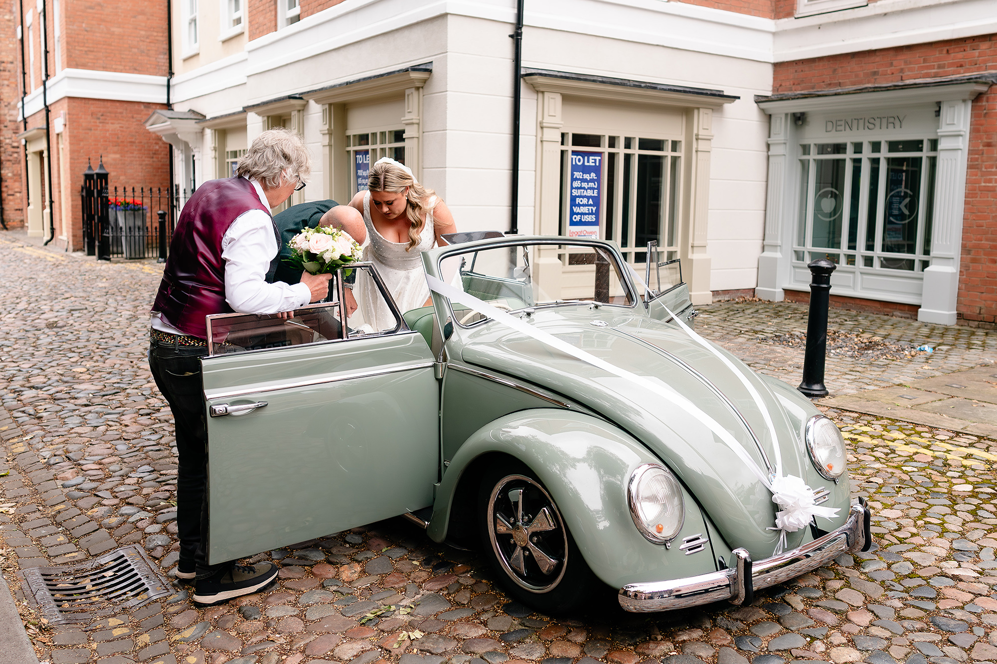 The vintage VW Beetle wedding car arriving outside St Mary’s Church, Nantwich