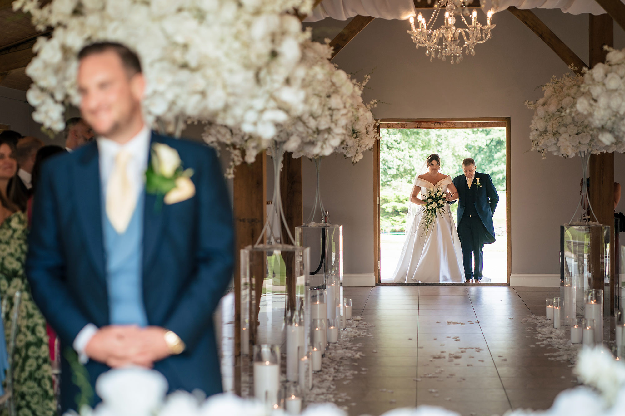 Laura arriving in the doorway on her dad's arm, Merrydale Manor wedding photographer