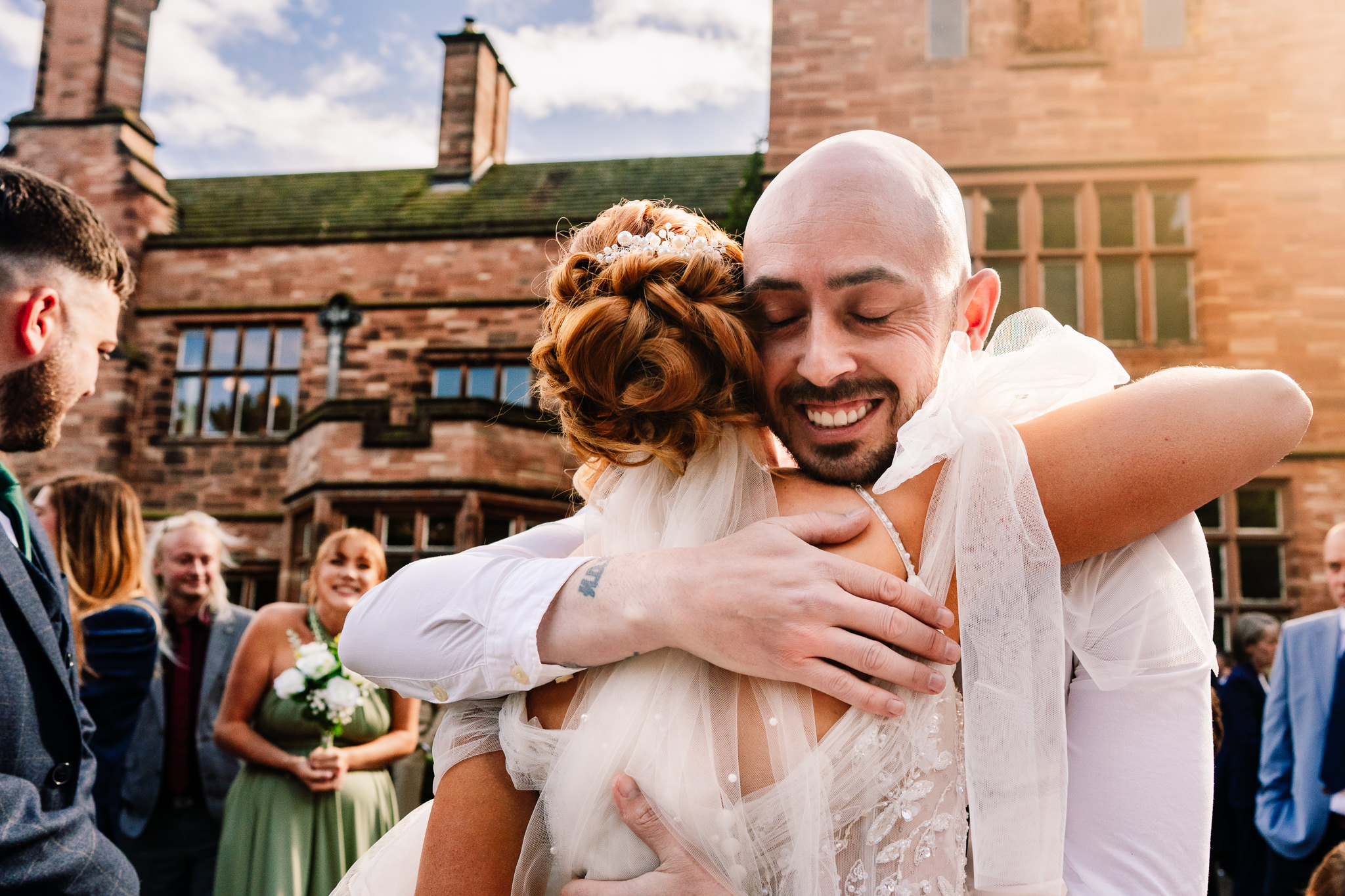 A guest embracing the bride in a warm congratulatory hug outside Salt House