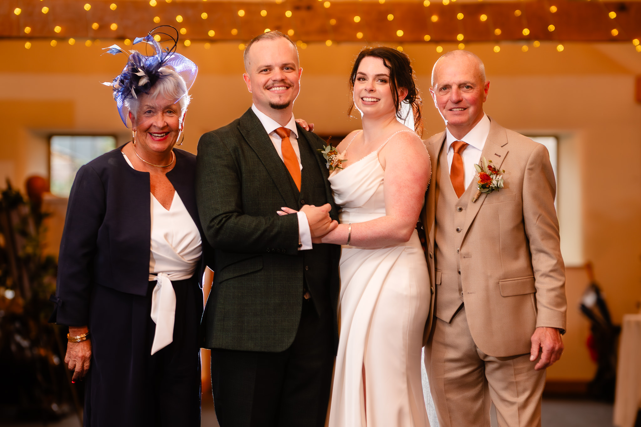 Bride and groom with the groom's parents during family photos at Heaton House Farm, Cheshire wedding photographer