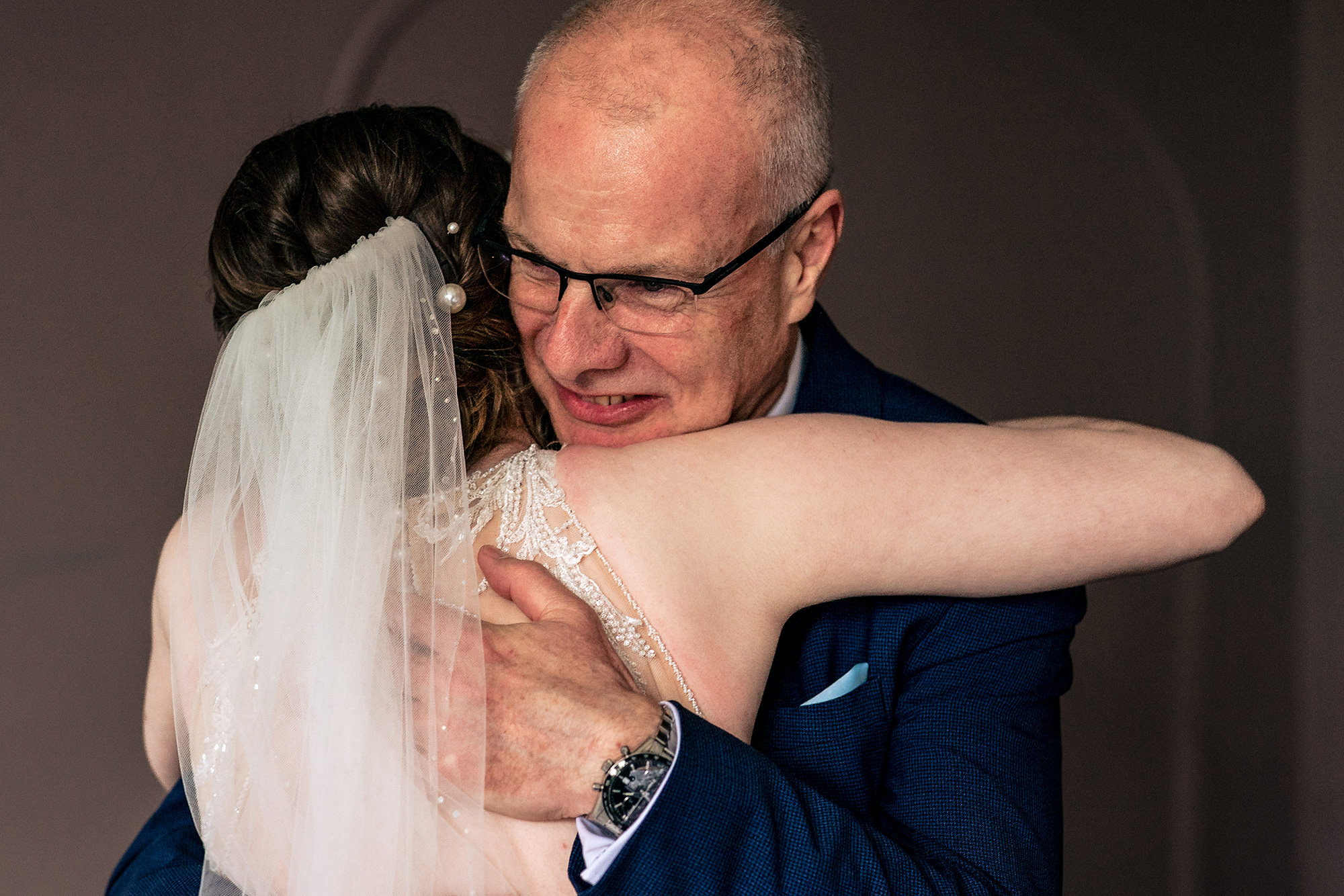 Bride’s dad hugging her tightly before the ceremony begins, Salt House wedding photographer