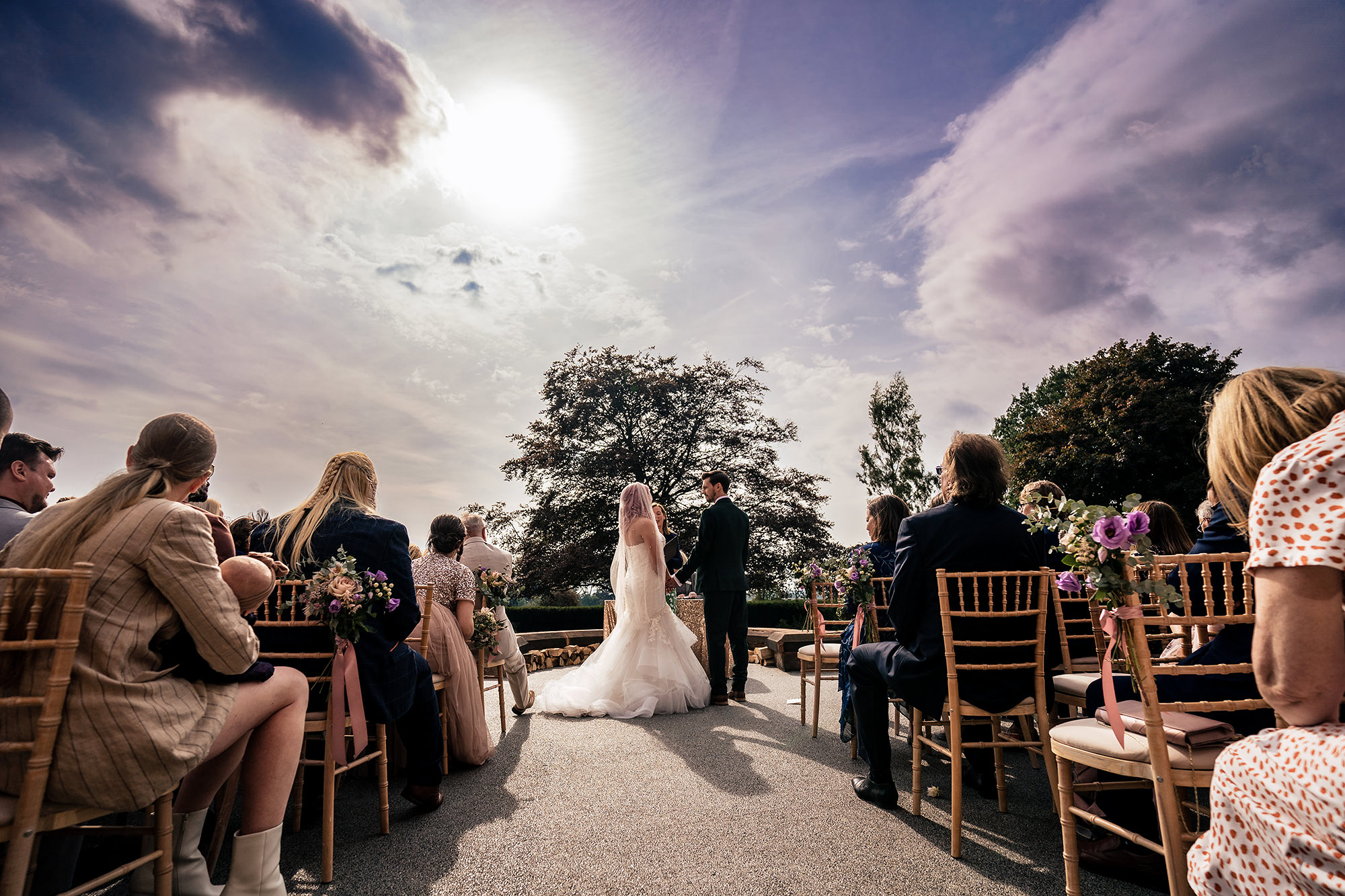 Bride and groom at the altar during their outdoor ceremony on the terrace at Standon Hall