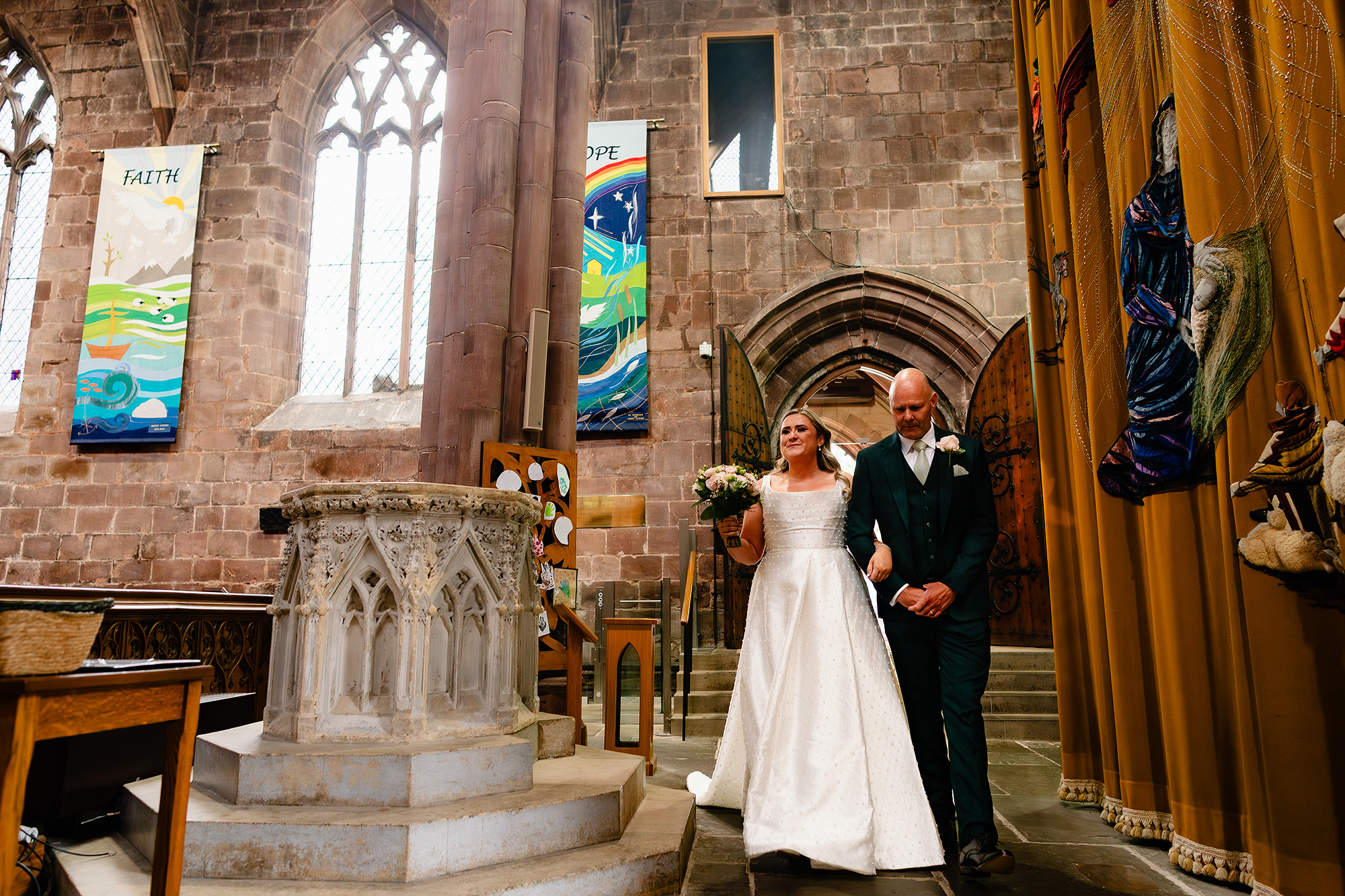 Chloe’s bridal portrait with her bouquet in the doorway light at St Mary’s Church, Nantwich