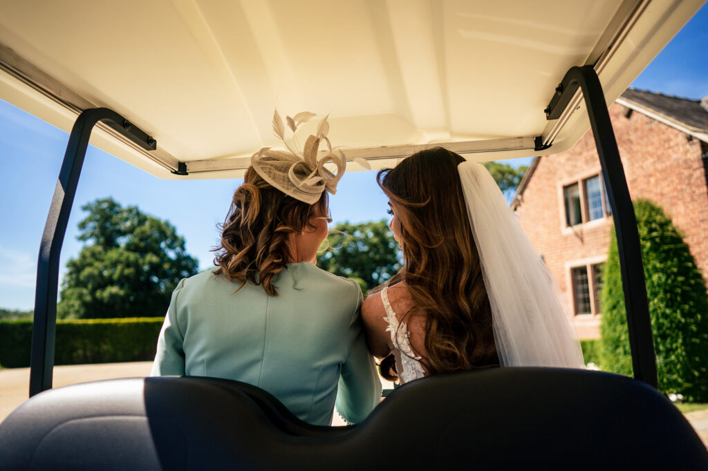 Gemma and her mum riding a golf buggy to the ceremony at Merrydale Manor