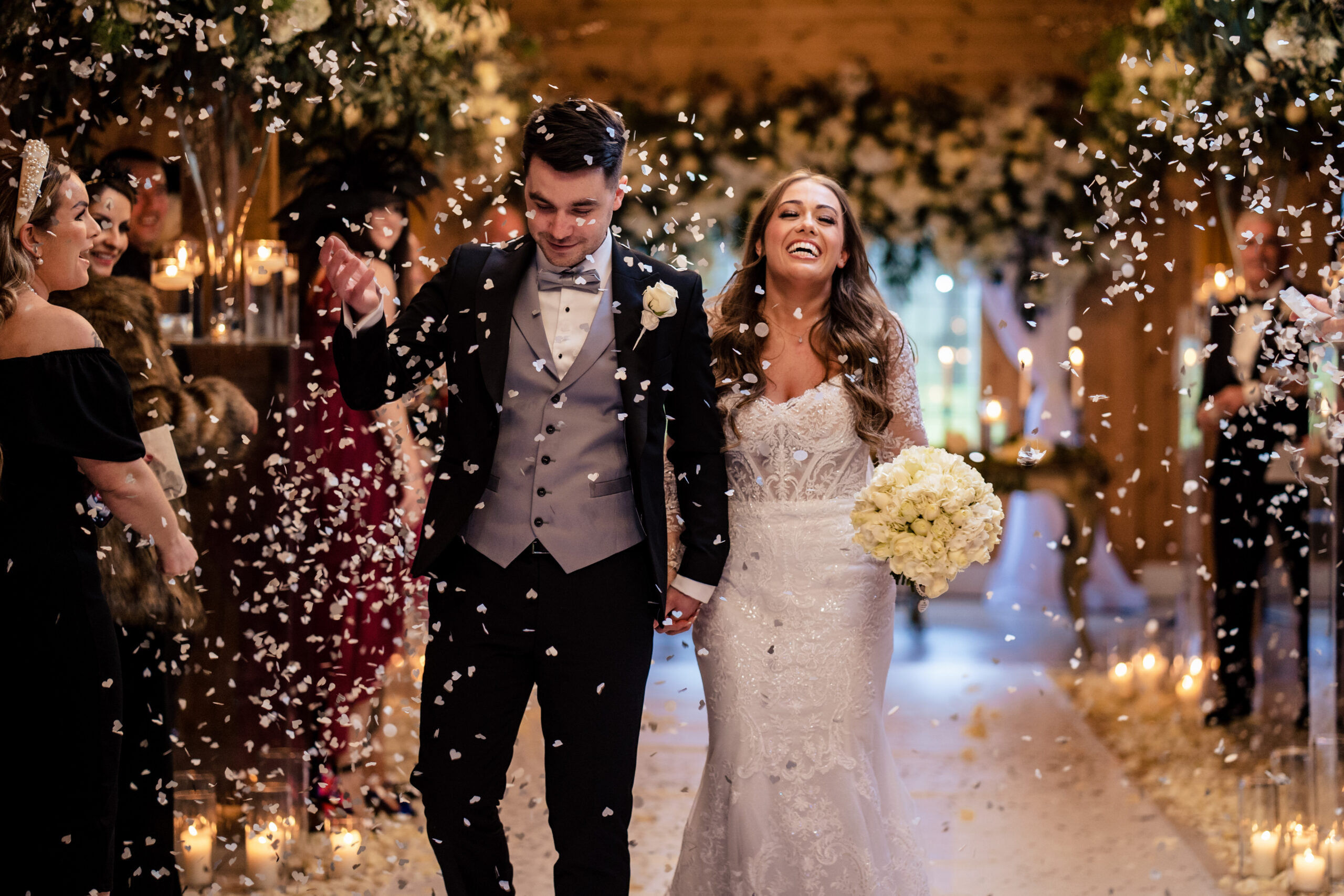 Abbie and Jamie laughing through the confetti, Cheshire wedding photographer