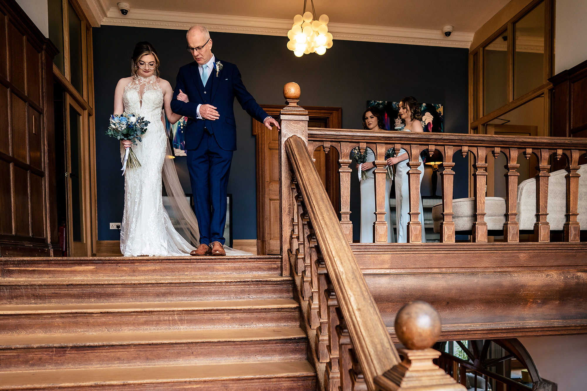 Bride and her dad walking down the grand staircase at Salt House on their way to the ceremony, Staffordshire wedding photographer
