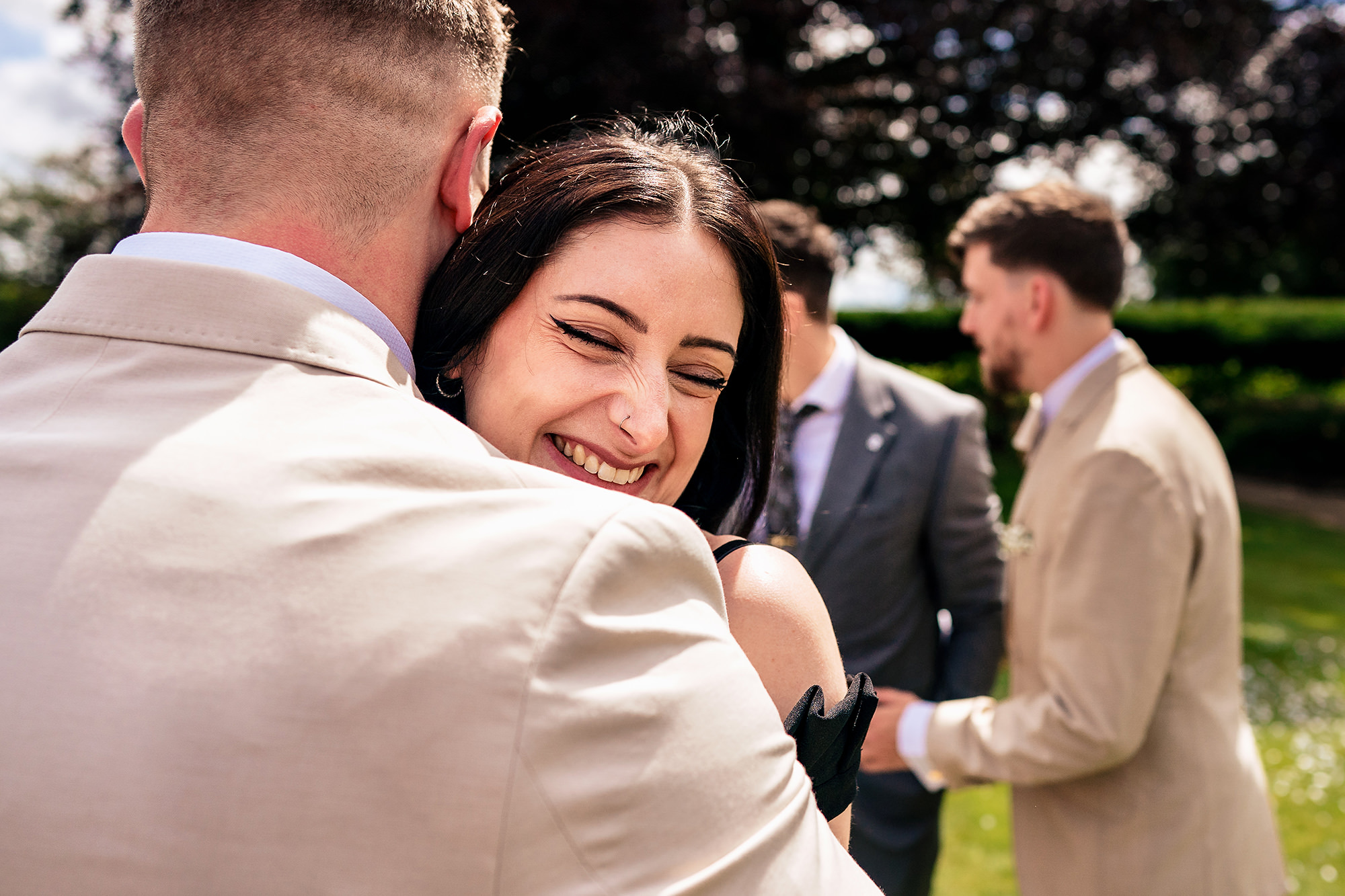 Jess hugging a guest after the ceremony at her Salt House wedding, Staffordshire