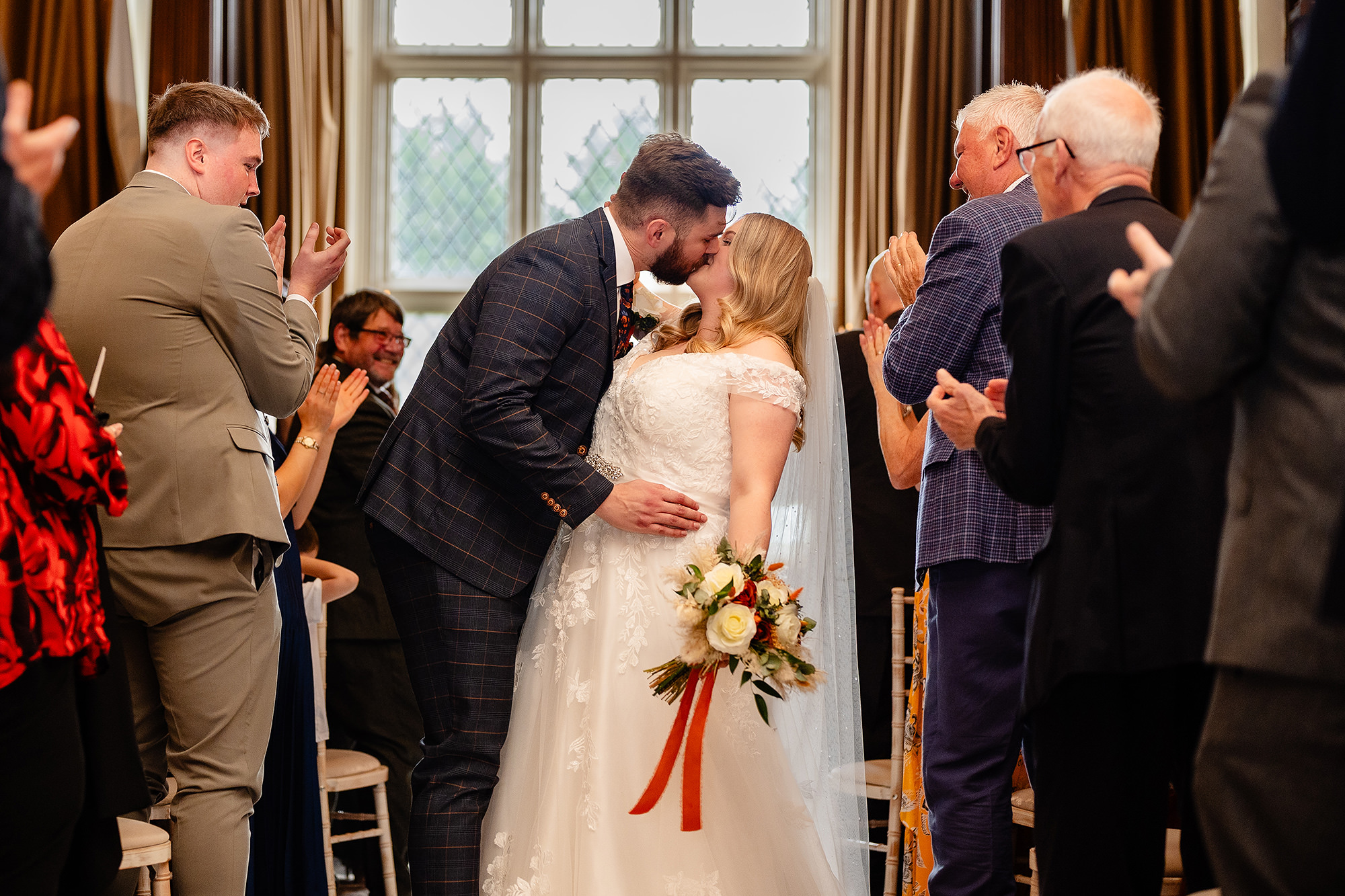 Guests clapping as Annie and Tom make their way out after the ceremony, Crewe Hall wedding photographer