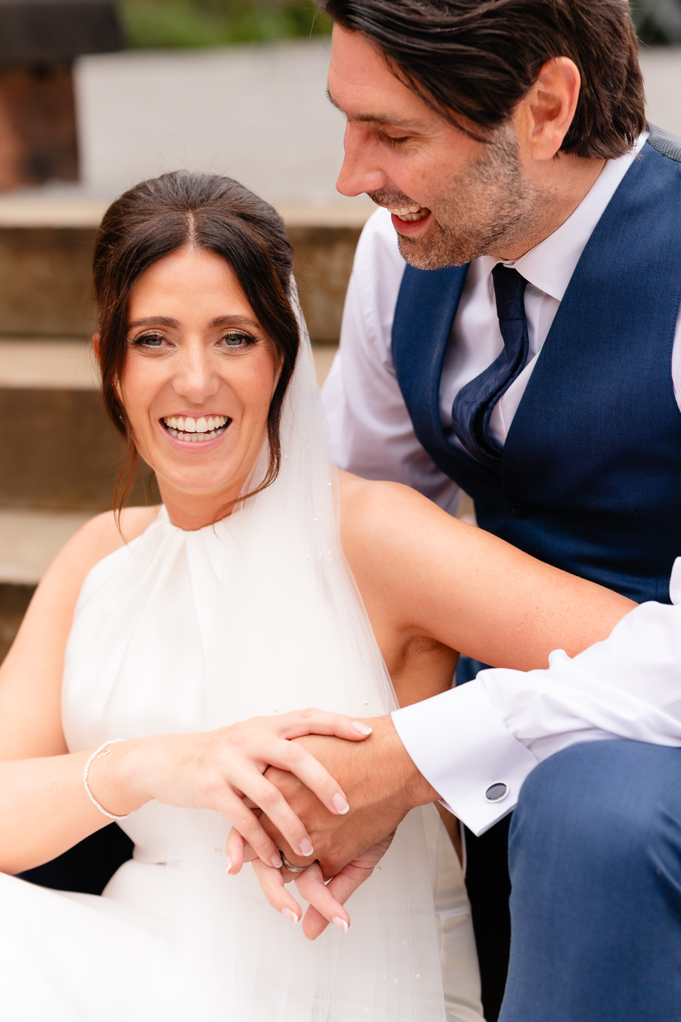 Close up portrait of bride and groom laughing on the steps at Salt House, Staffordshire wedding photographer
