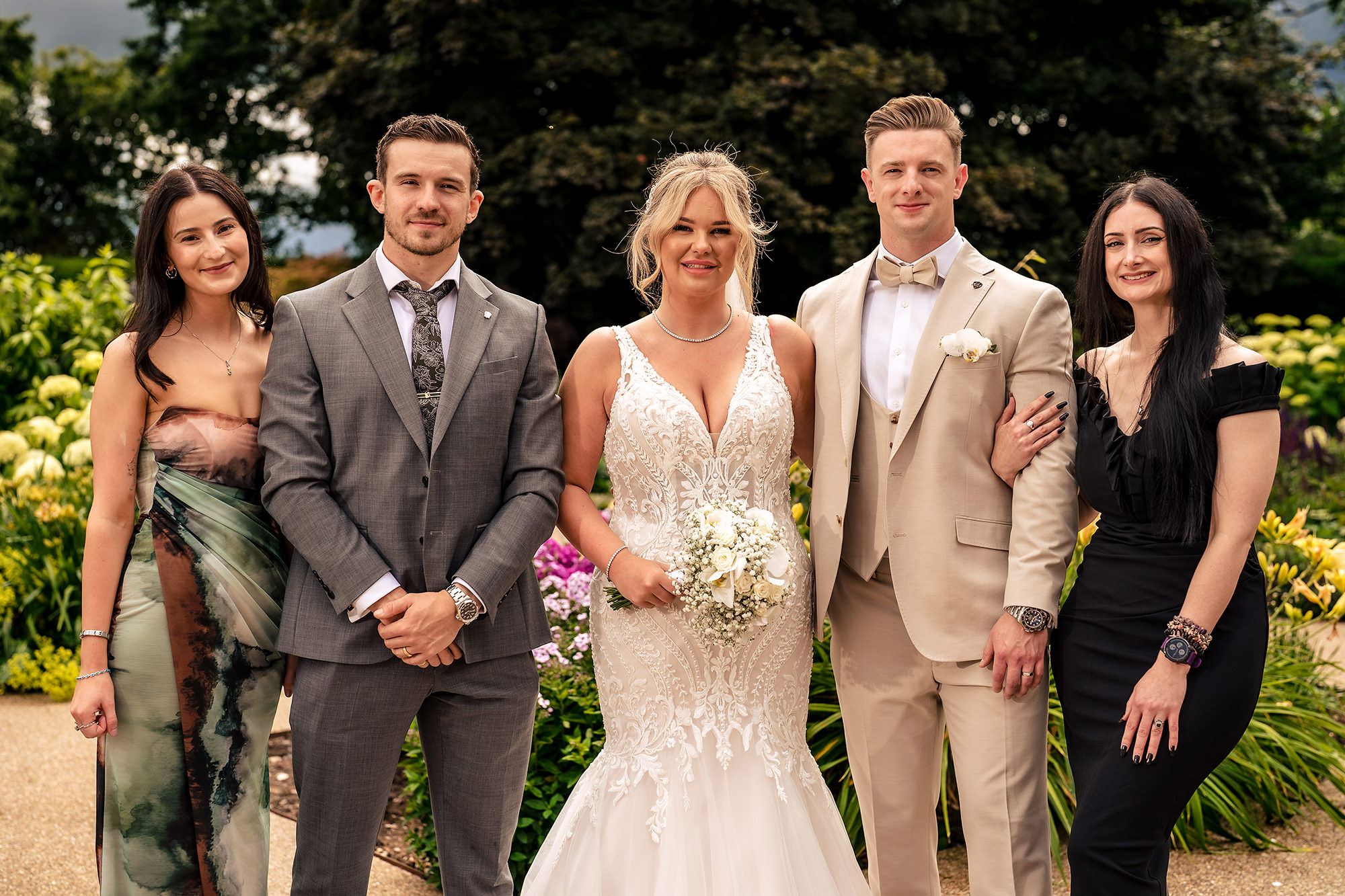 Jess and Cy with close friends in the gardens at Salt House, Staffordshire wedding photographer