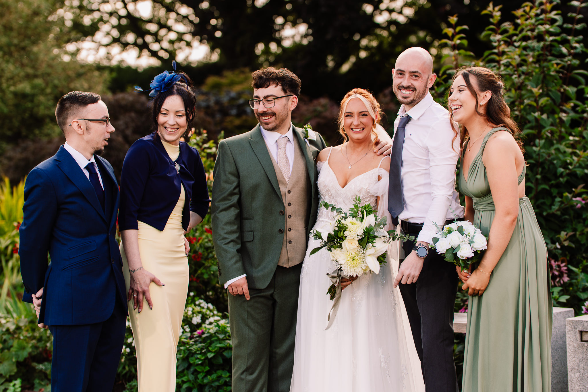 Bride and groom with family members gathered for a formal photo at Salt House