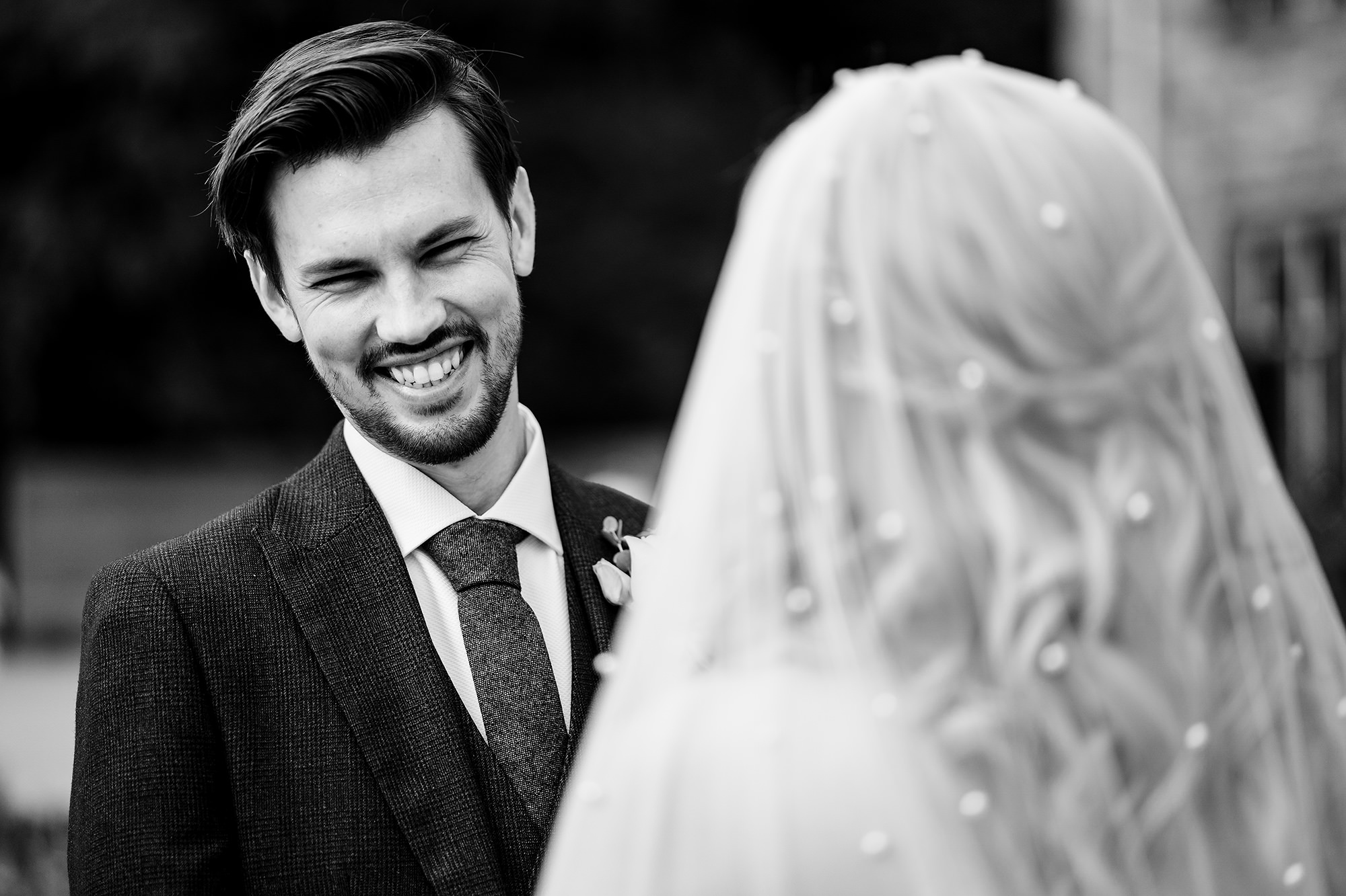 Black and white portrait of the groom’s reaction as his bride arrives at the ceremony, Standon Hall wedding photographer