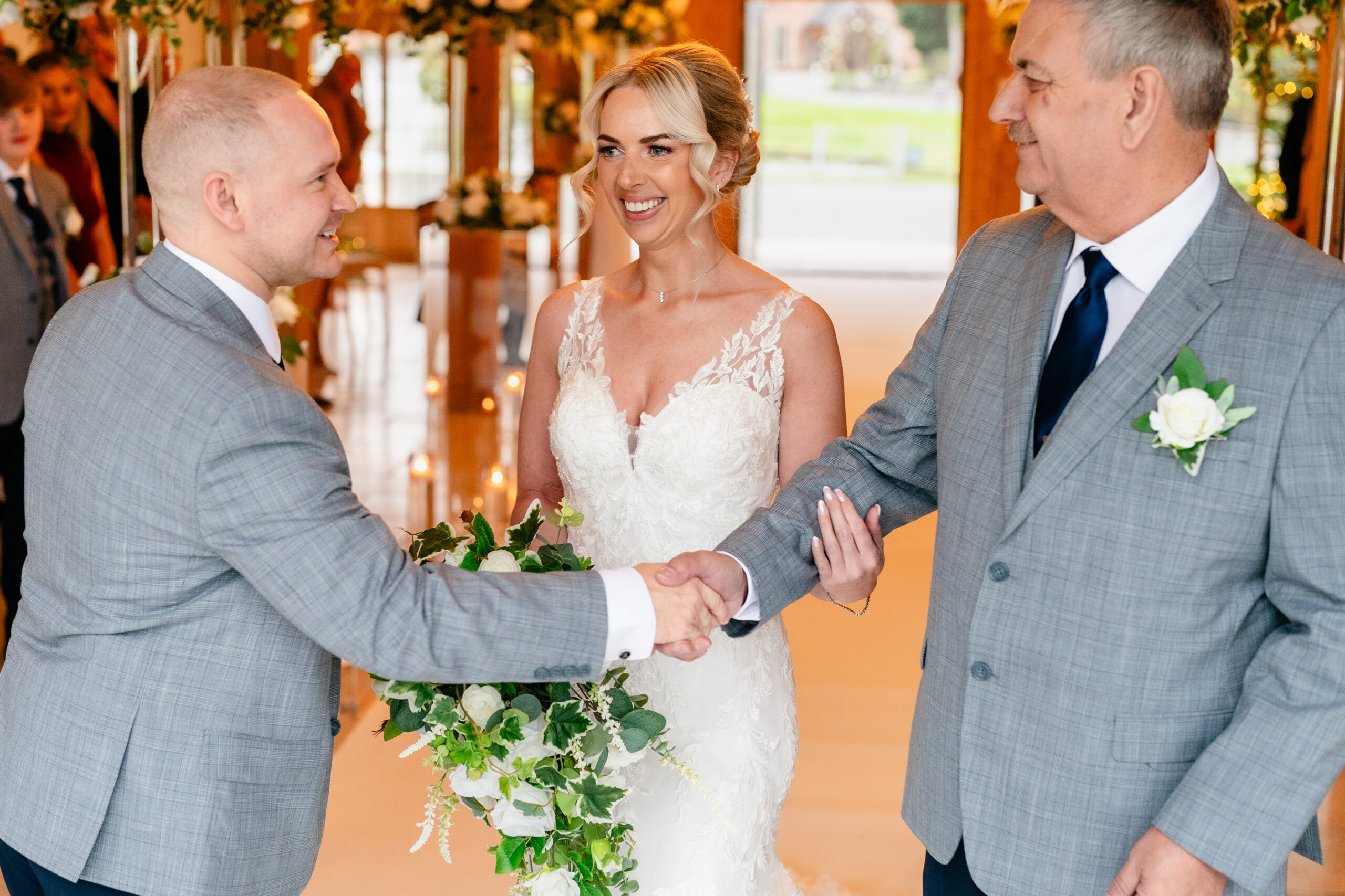 The bride's dad shaking the groom's hand as he hands her over at the top of the aisle, Colshaw Hall wedding photographer