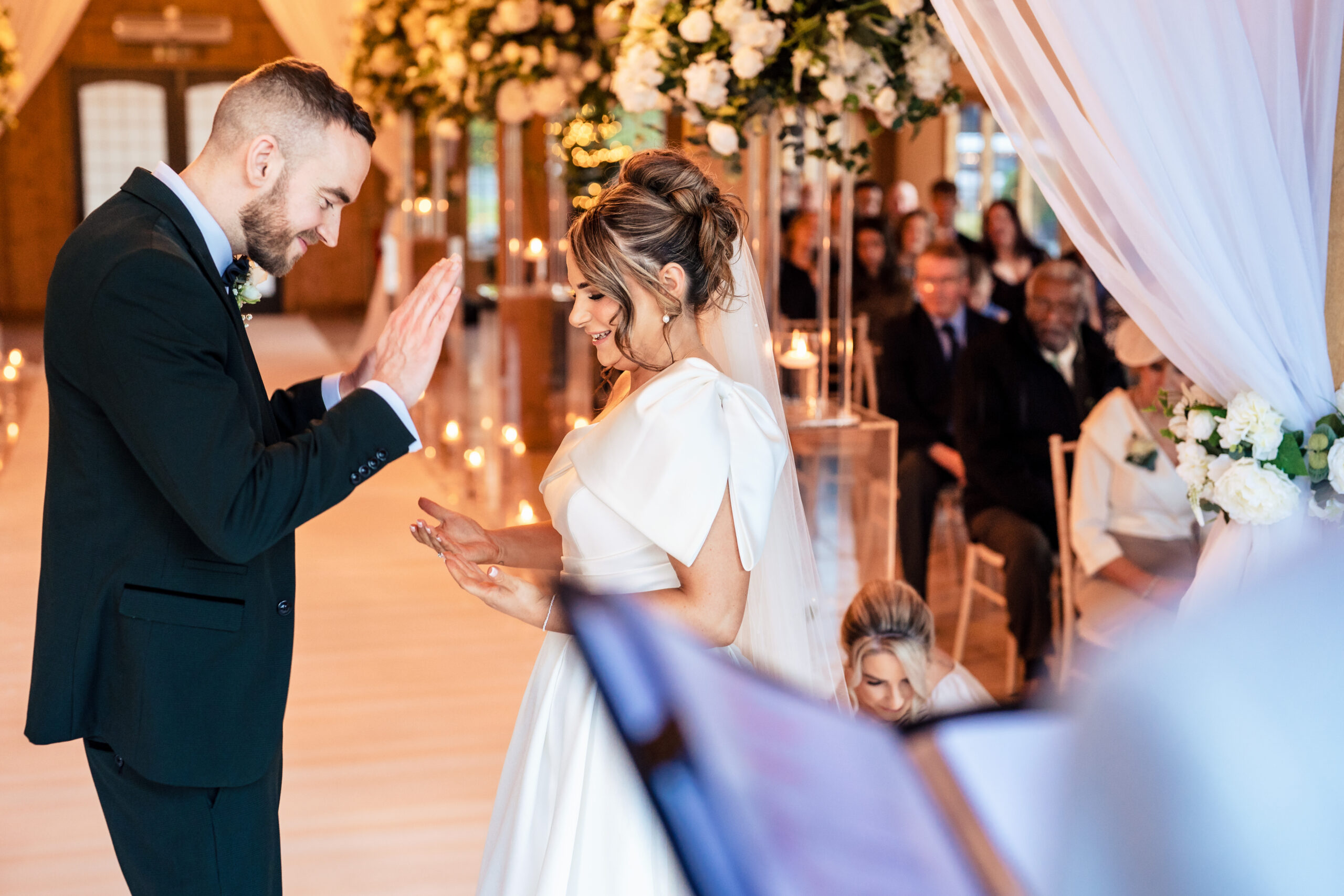 Joe clapping during the ceremony as the couple stood at the front of the room