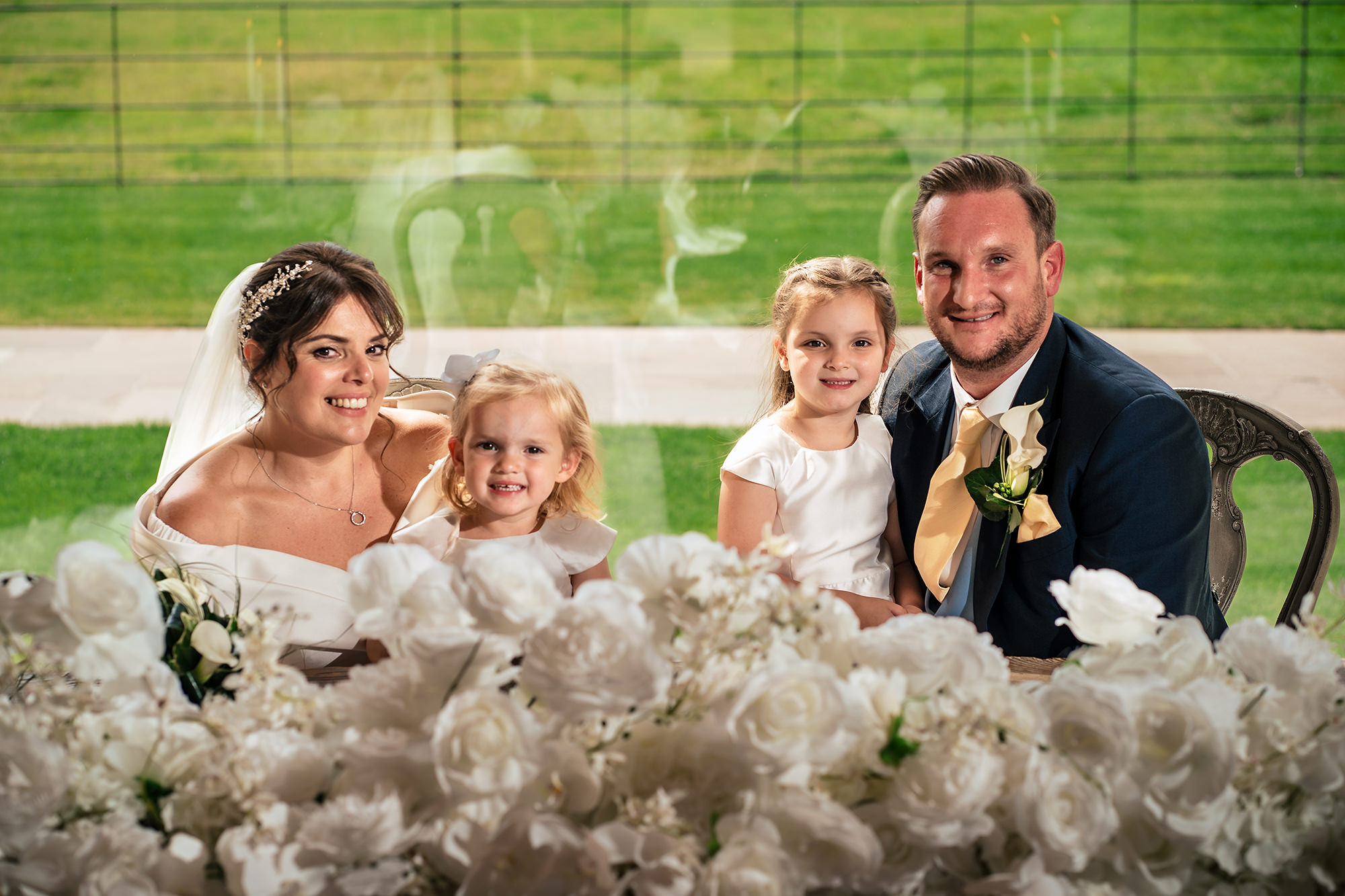Laura with her bridesmaids surrounded by flowers just after the ceremony, Merrydale Manor wedding photographer