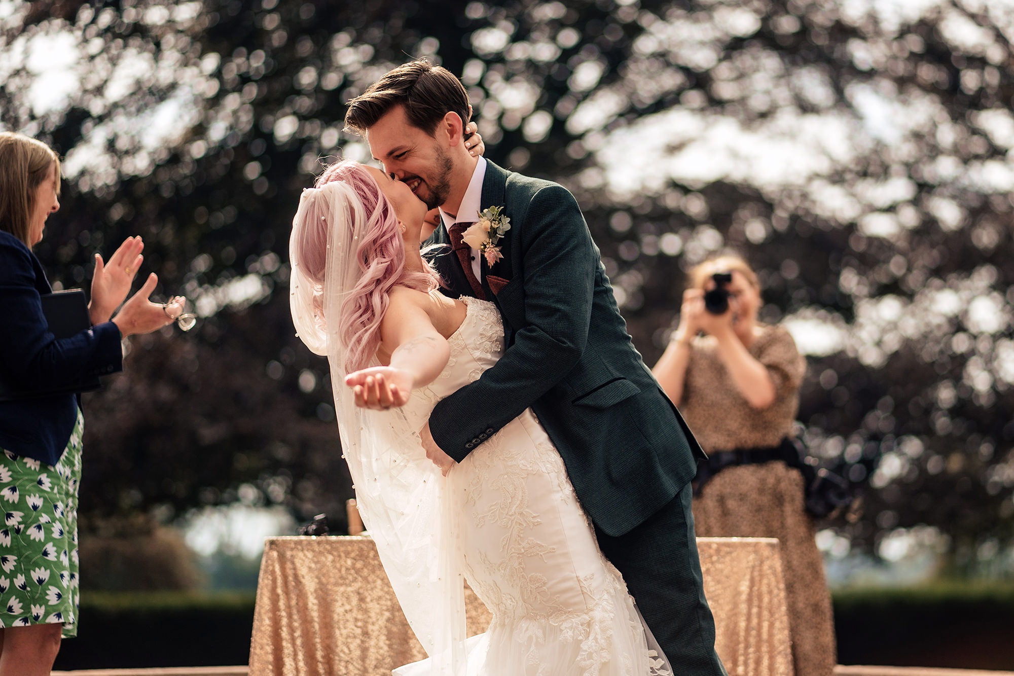 Groom dipping his bride for their first kiss as newlyweds at Standon Hall