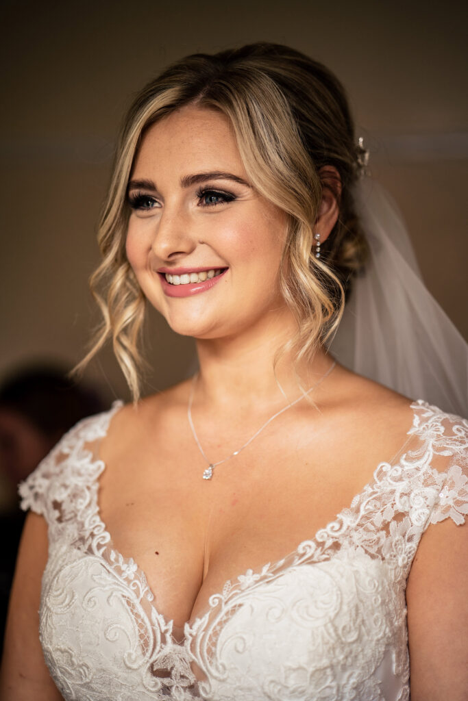 Portrait of the smiling bride in her lace wedding dress and veil, Merrydale Manor wedding photographer