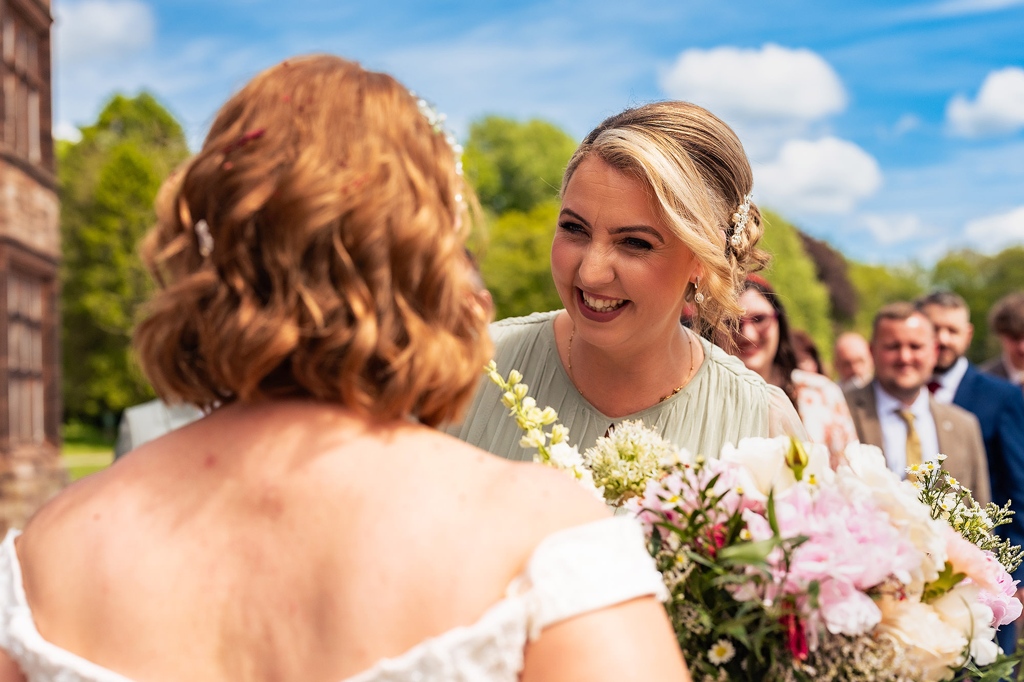 Bride hugging an older guest with delight straight after her wedding ceremony at Salt House
