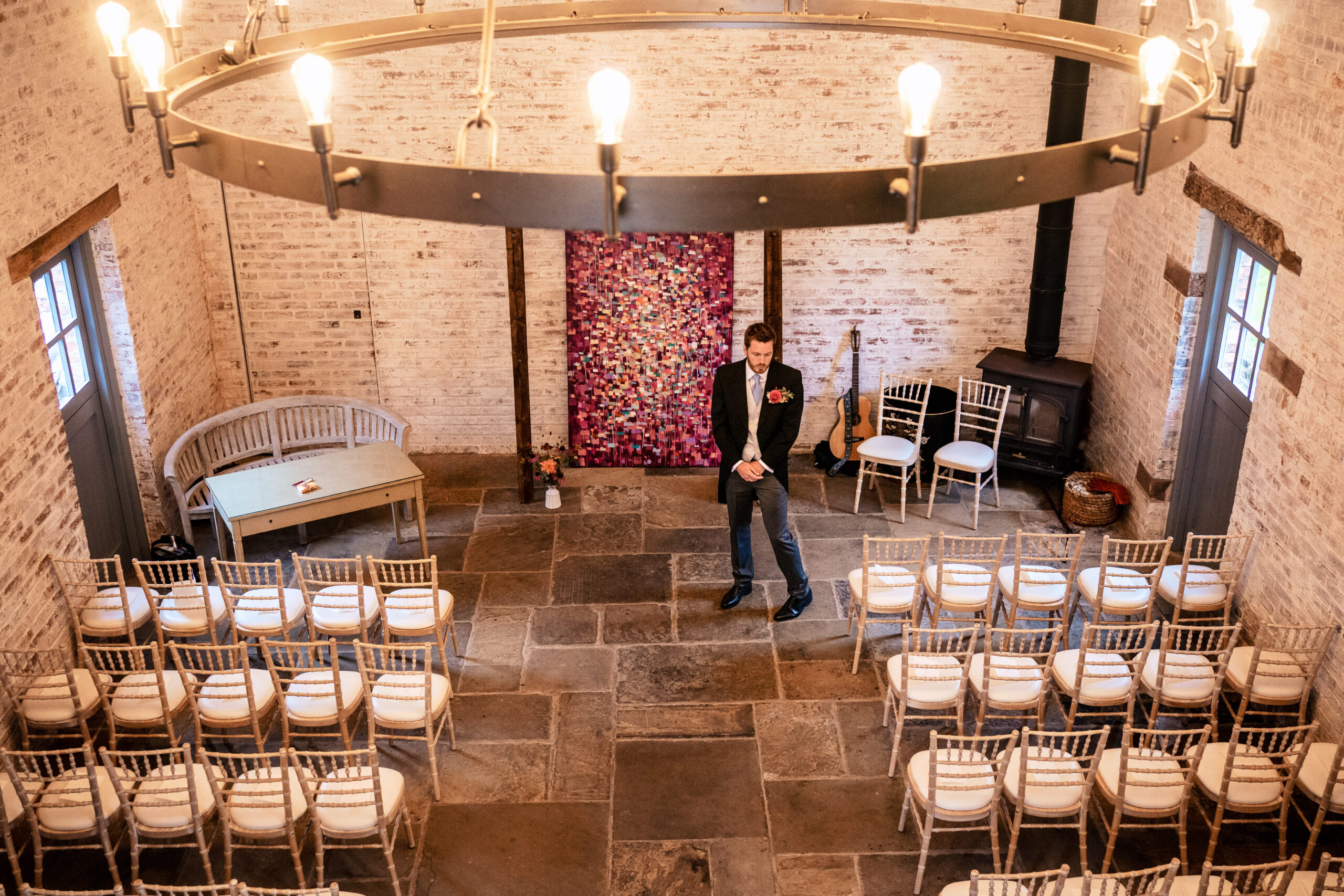 The Coach House at Dorfold Hall set up for a wedding ceremony with a flower wall backdrop