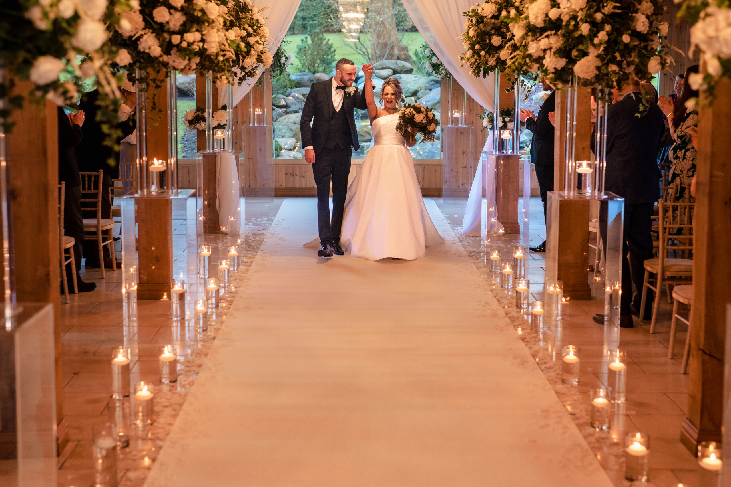Walking back down the aisle at Colshaw Hall past candles and drapes