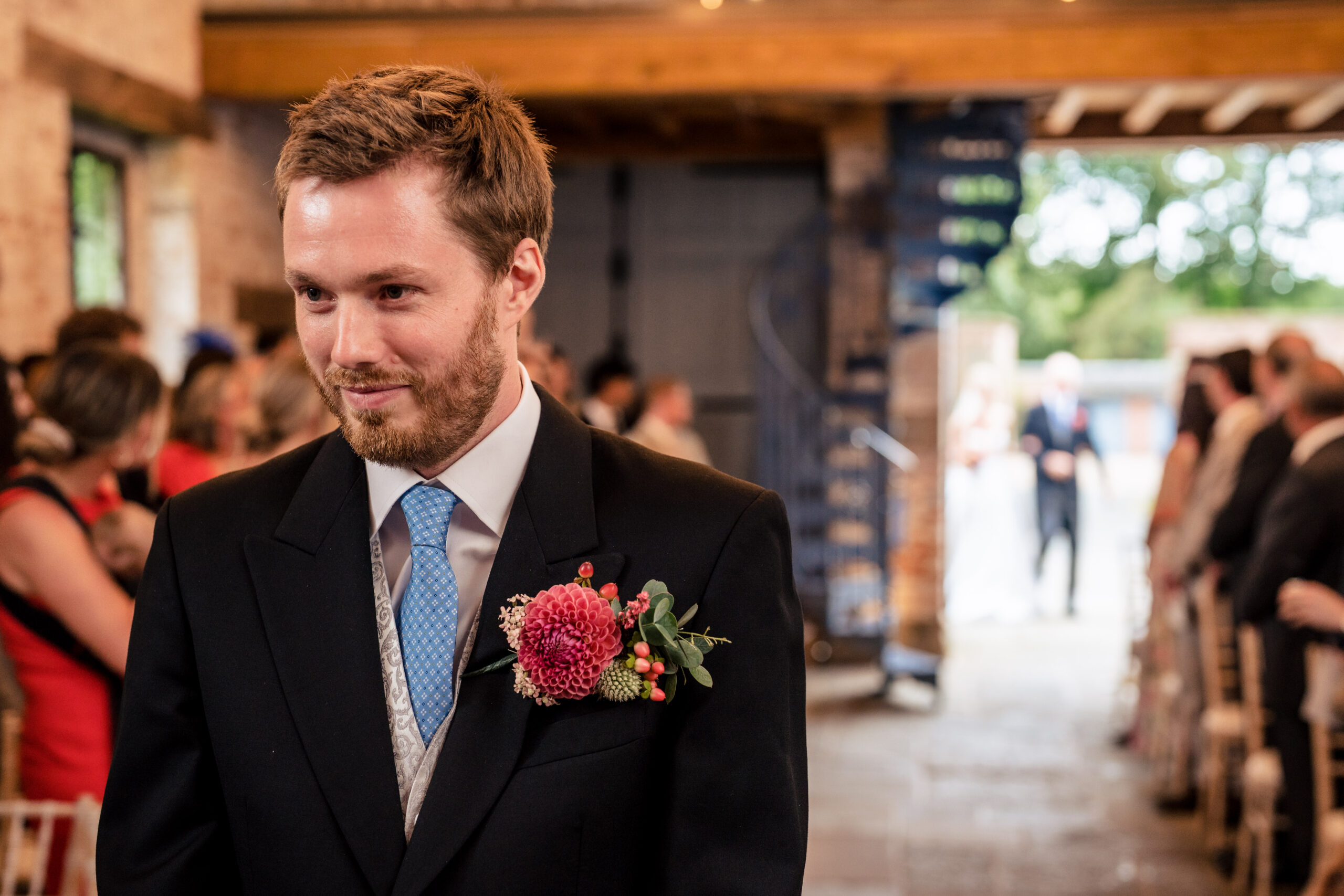 Groom waiting at the front of the Coach House as the bridal party arrives, Dorfold Hall wedding photographer