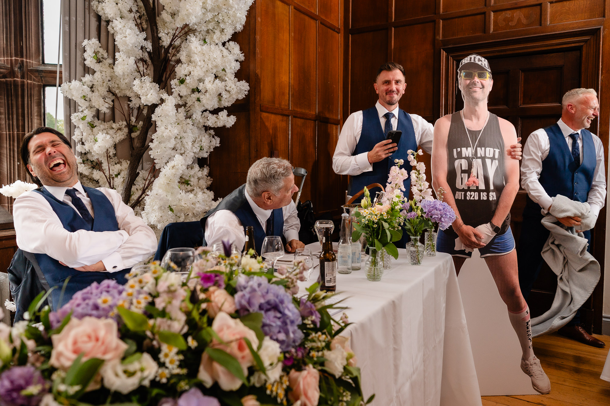 Guests laughing during the best man's speech with a novelty cardboard cutout, Salt House Staffordshire wedding photographer