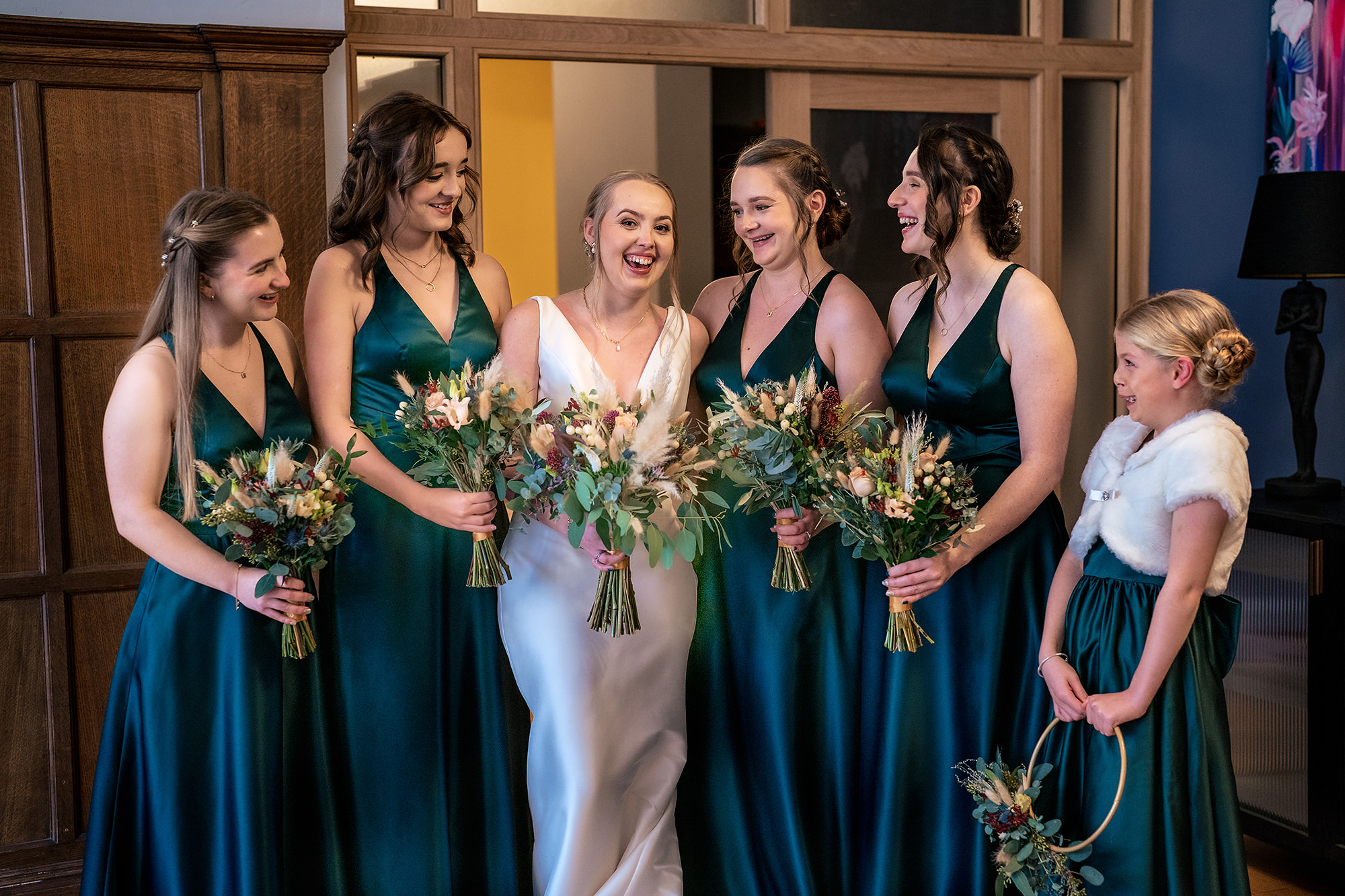Chloe’s bridesmaids in emerald green from The Bridal Lounge on the Salt House staircase