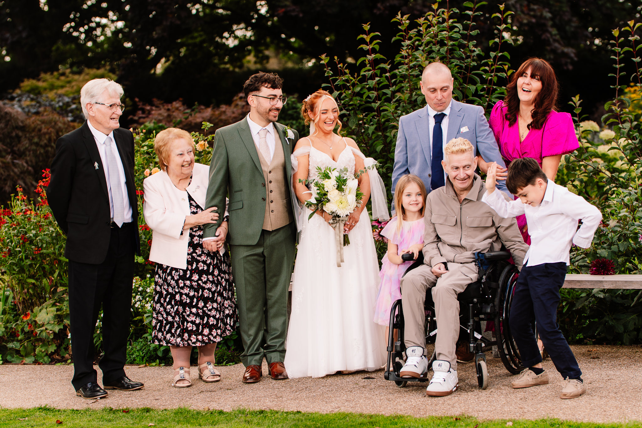 Bride and groom pictured with family in the gardens at Salt House, Staffordshire wedding photographer