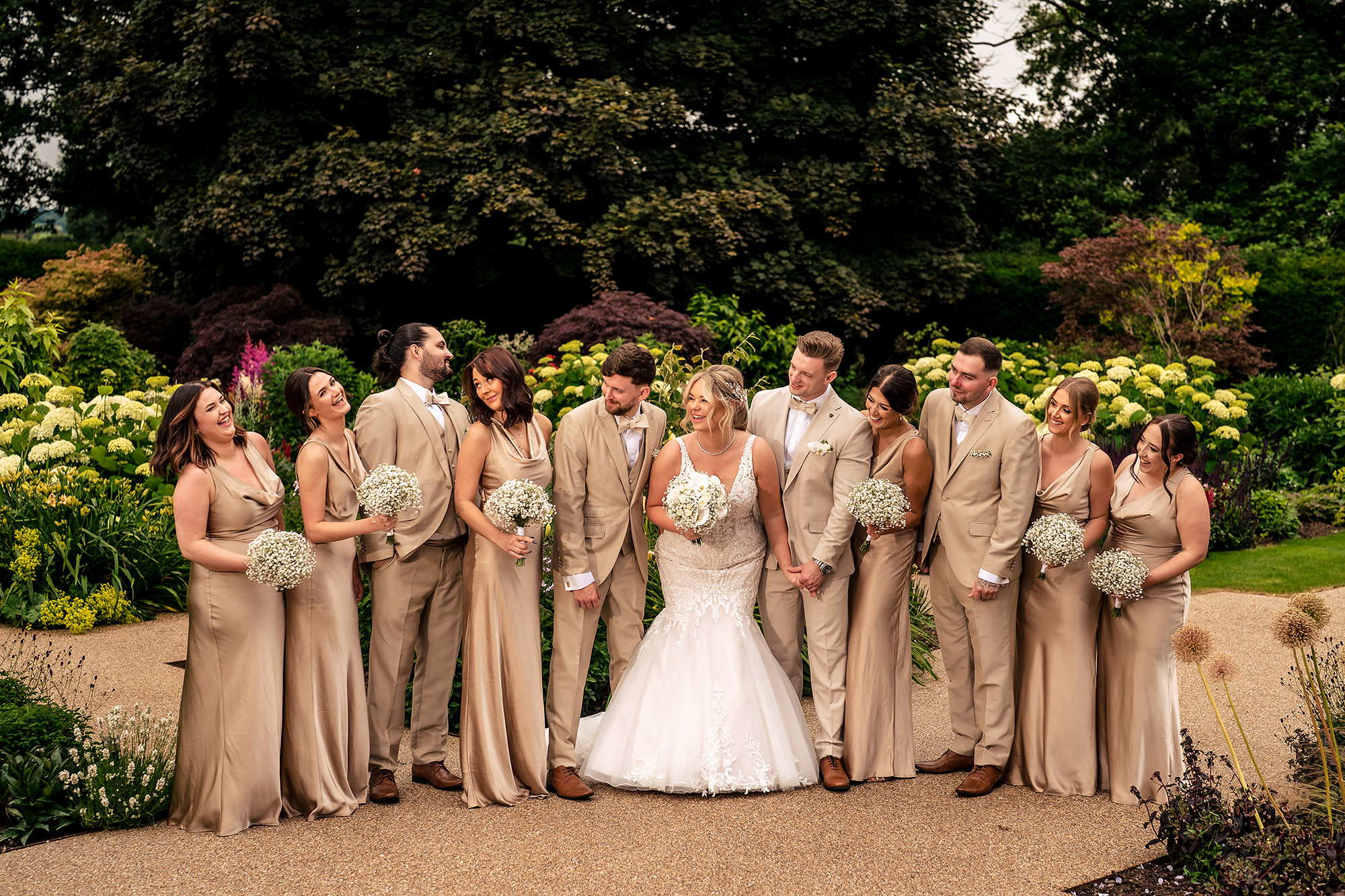 The bridal party laughing together in the gardens at Salt House, Staffordshire wedding photographer