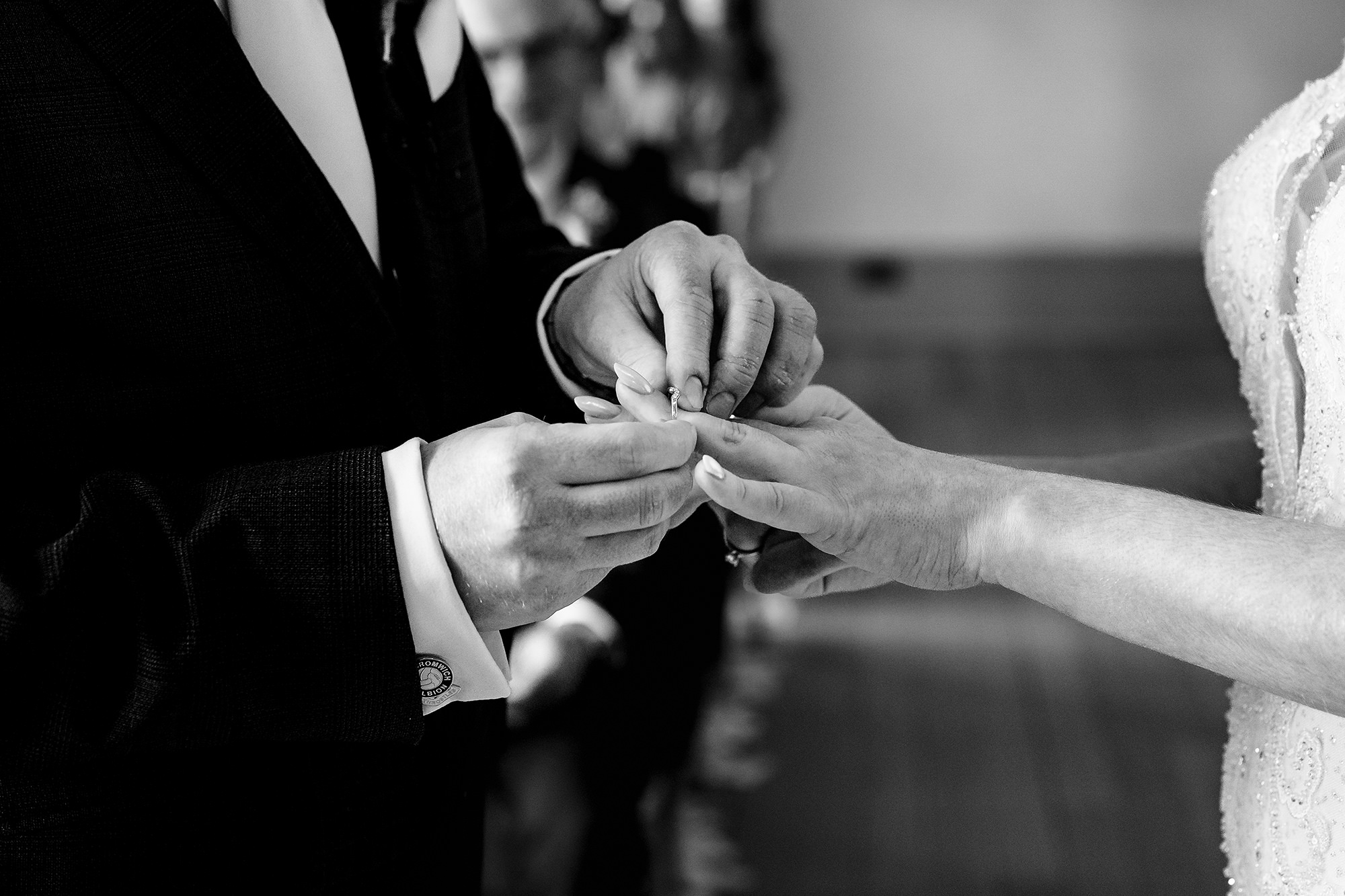 Close up of the ring exchange during the ceremony, black and white, Salt House wedding photographer