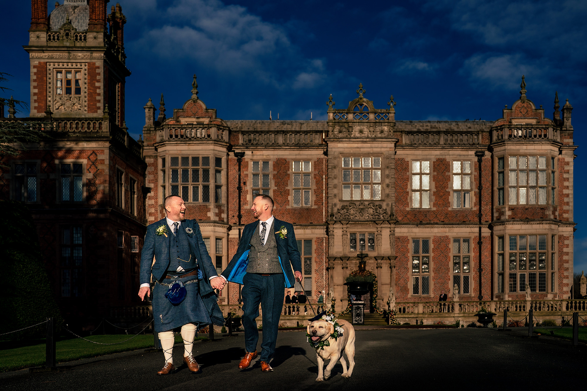 John, Neill and Sula outside the striking red brick front of Crewe Hall