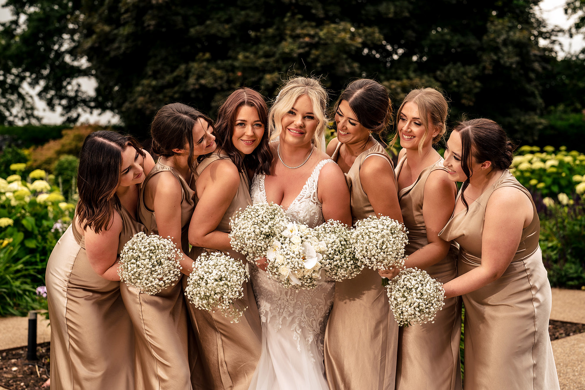 Jess surrounded by her bridesmaids and their gypsophila bouquets at Salt House