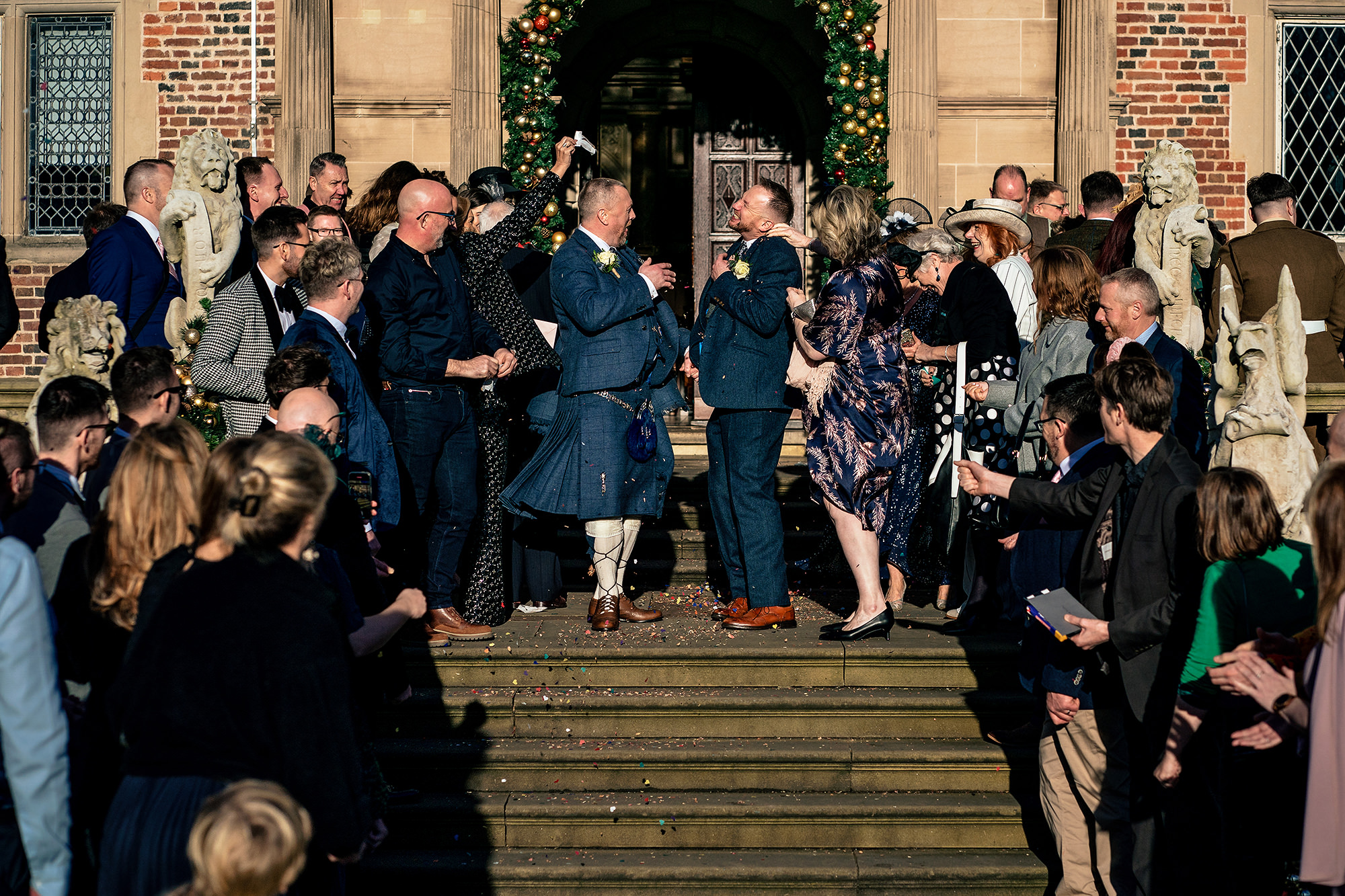 Confetti thrown from both sides as John and Neill came down the front steps of Crewe Hall