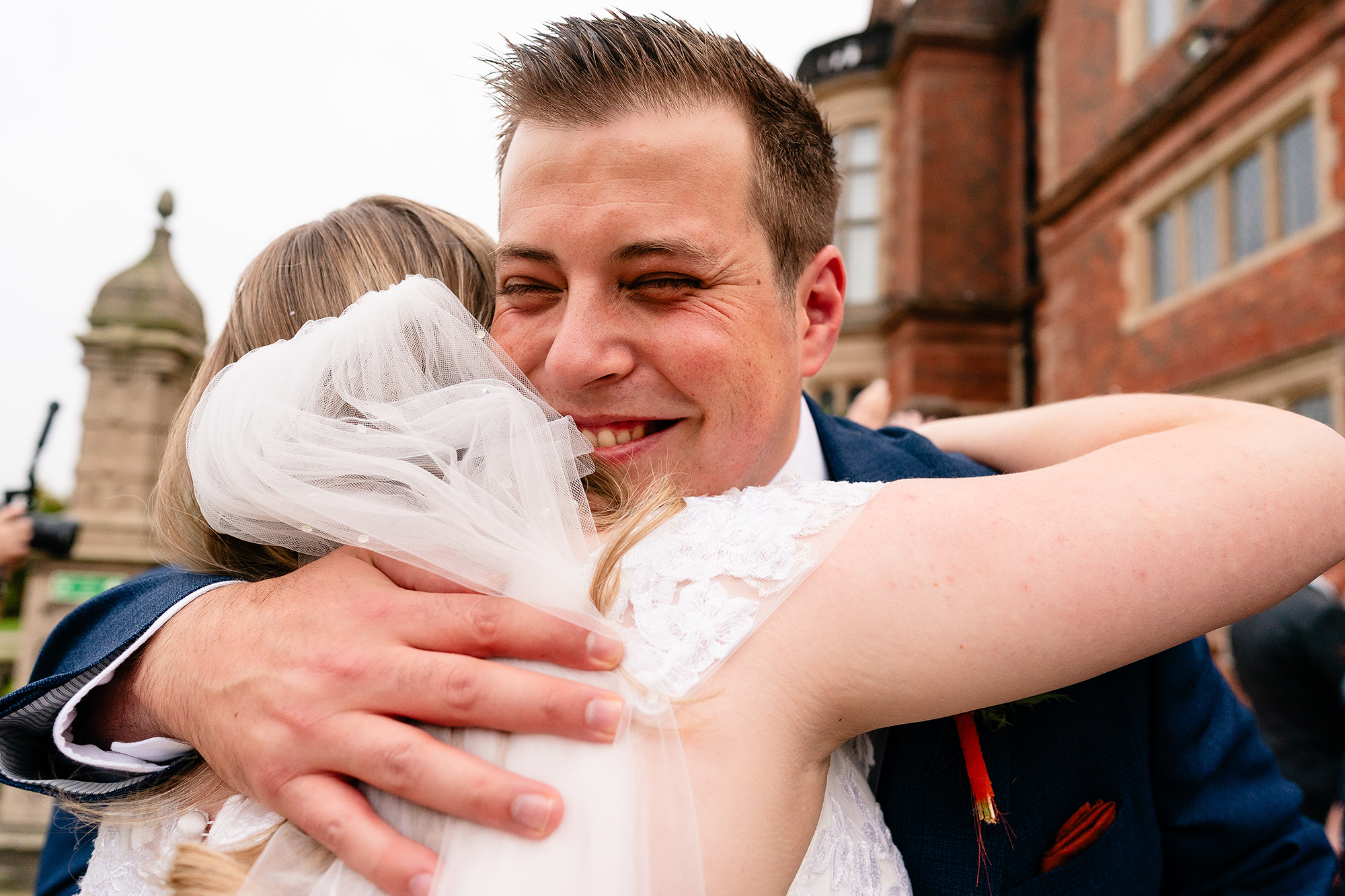 Tom and Annie laughing together, foreheads touching, after the ceremony, Crewe Hall wedding photographer