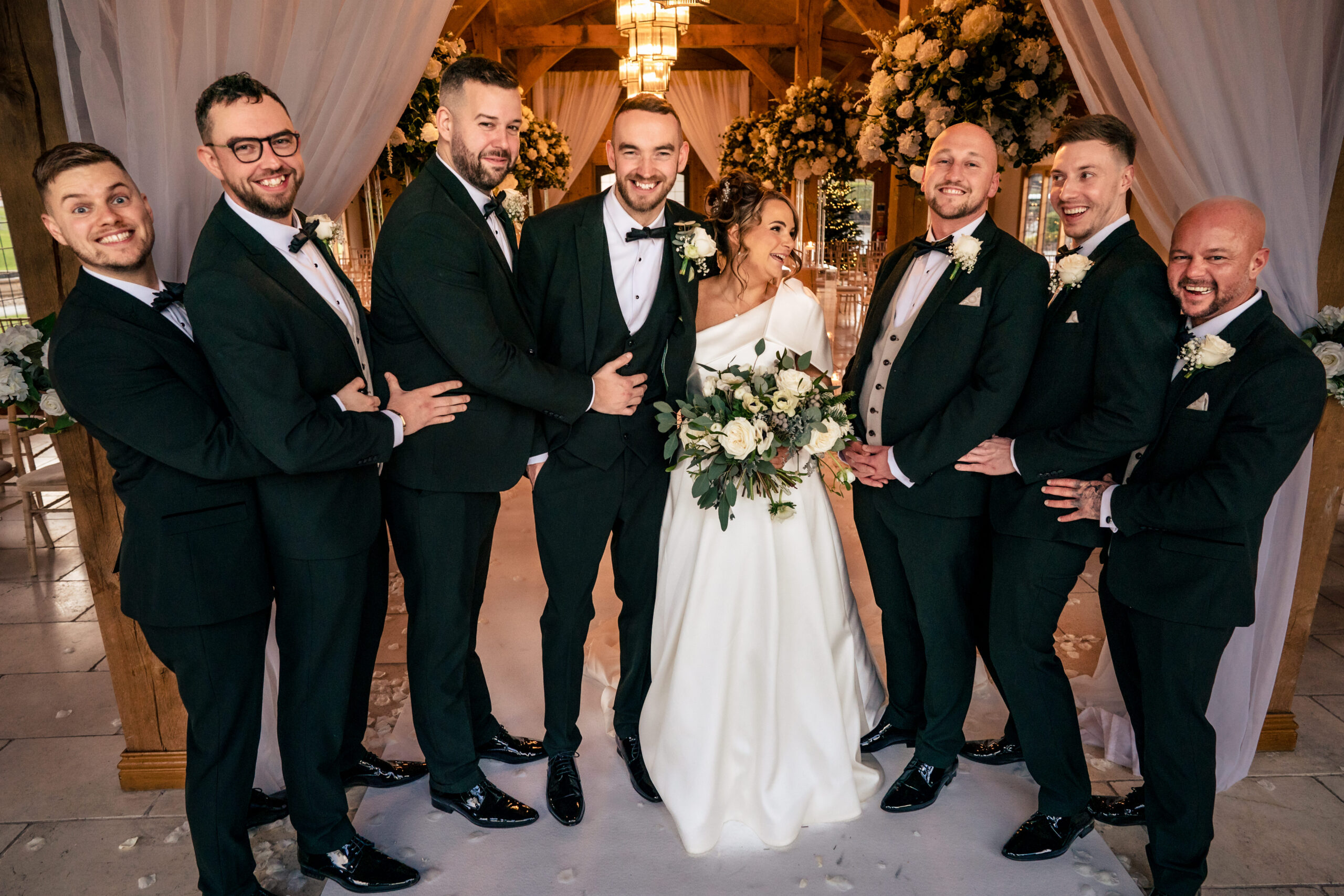 Joe and his groomsmen together at the floral arch