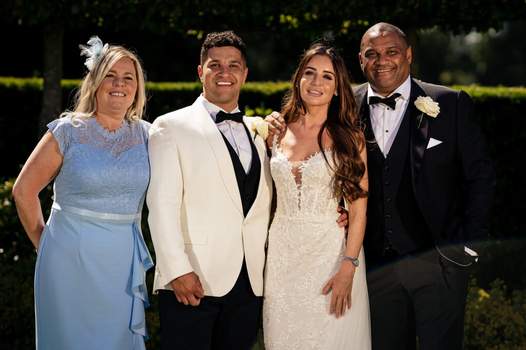 Gemma and Tyrone with Tyrone’s dad and family in the sunshine in the gardens at Merrydale Manor