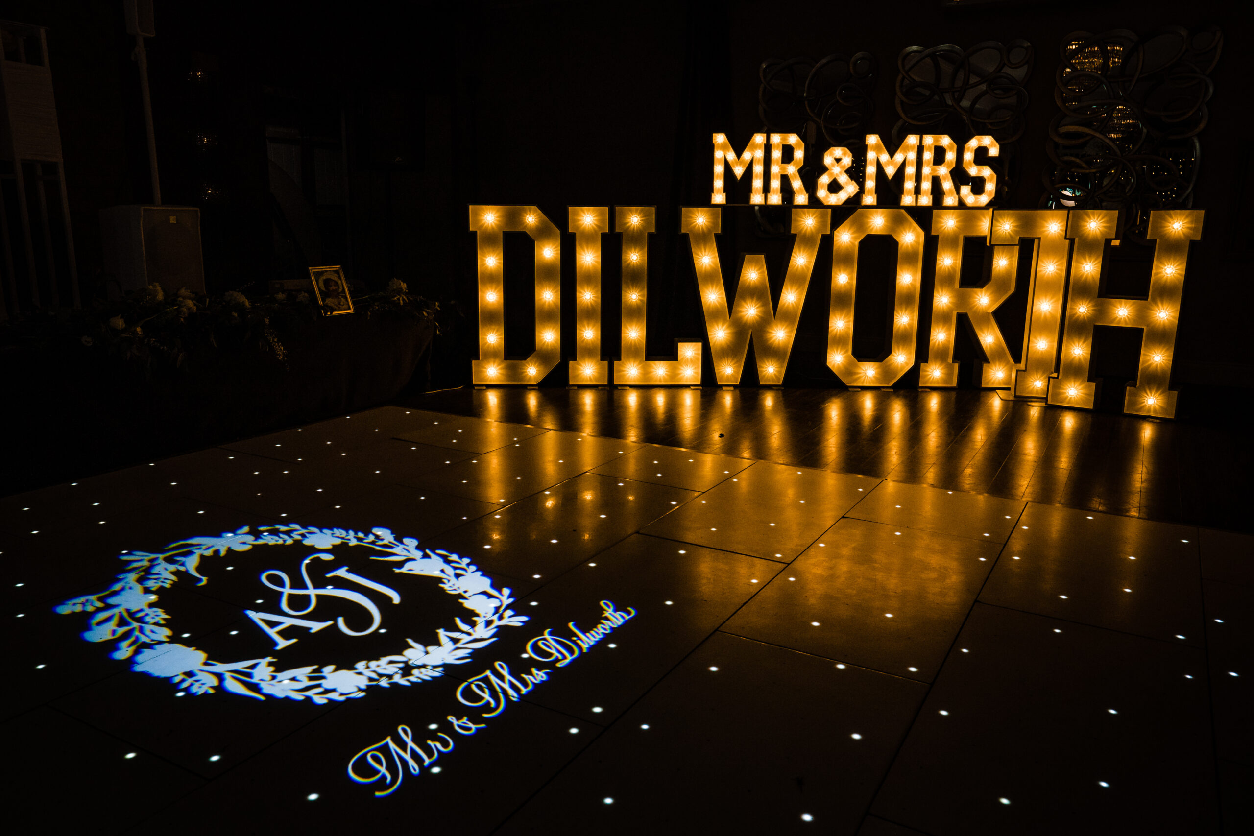 MR and MRS DILWORTH light up letters beside the starlit dance floor with an A and J monogram projection at Merrydale Manor