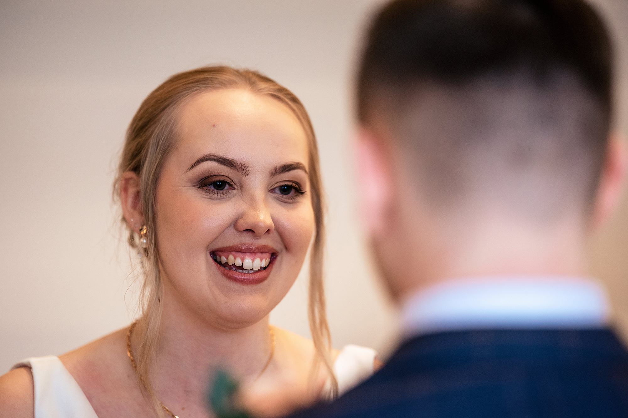 Chloe and Dan smiling through their vows at Salt House