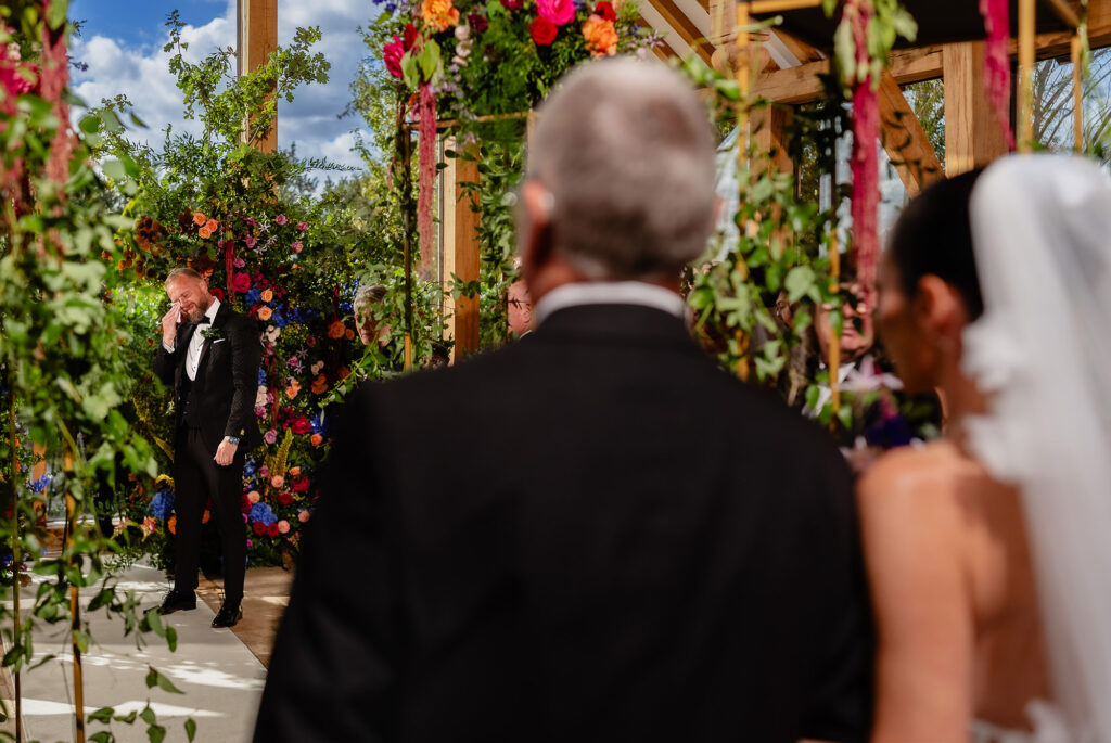 Glynn wiping his eyes at the front as Kim and her dad wait at the end of the aisle, Nottingham wedding photographer