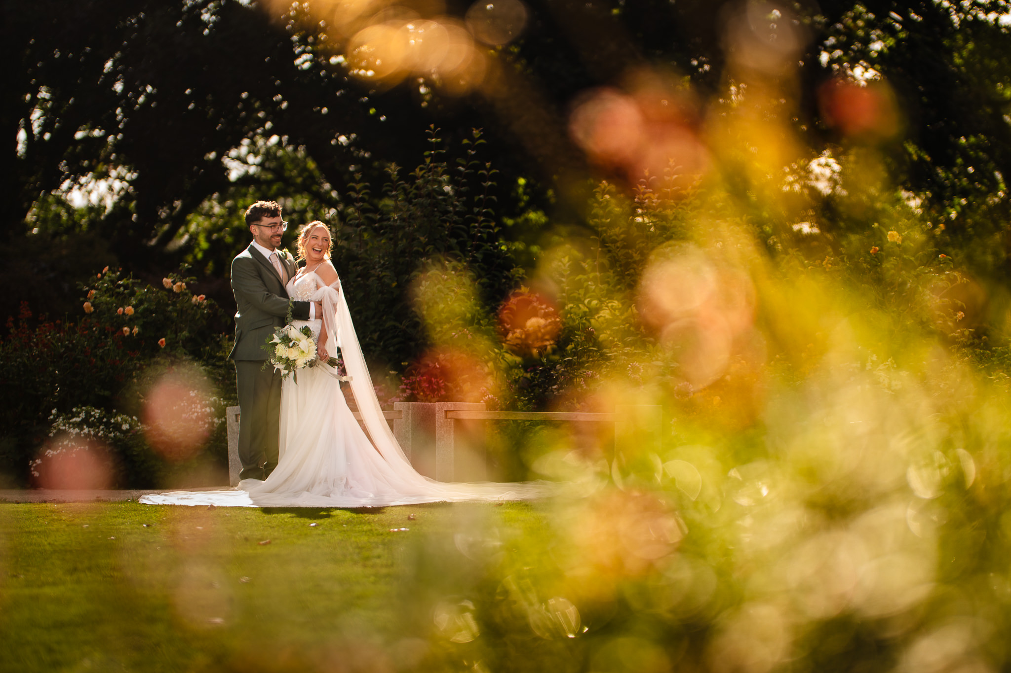 Bride and groom sharing a quiet moment together in golden light, framed by warm bokeh at Salt House