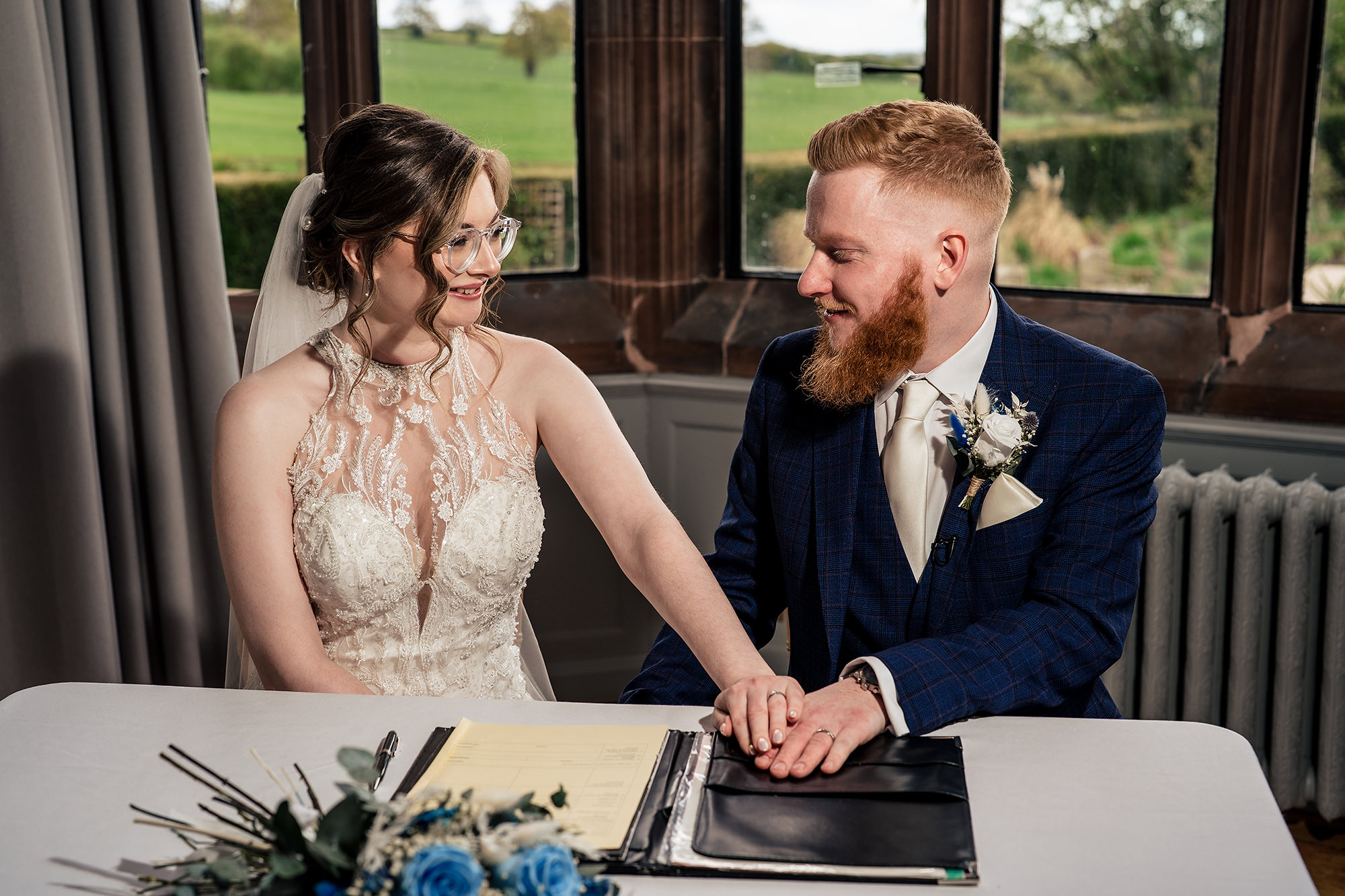 Bride and groom signing the register hand in hand after the ceremony, Salt House wedding photographer