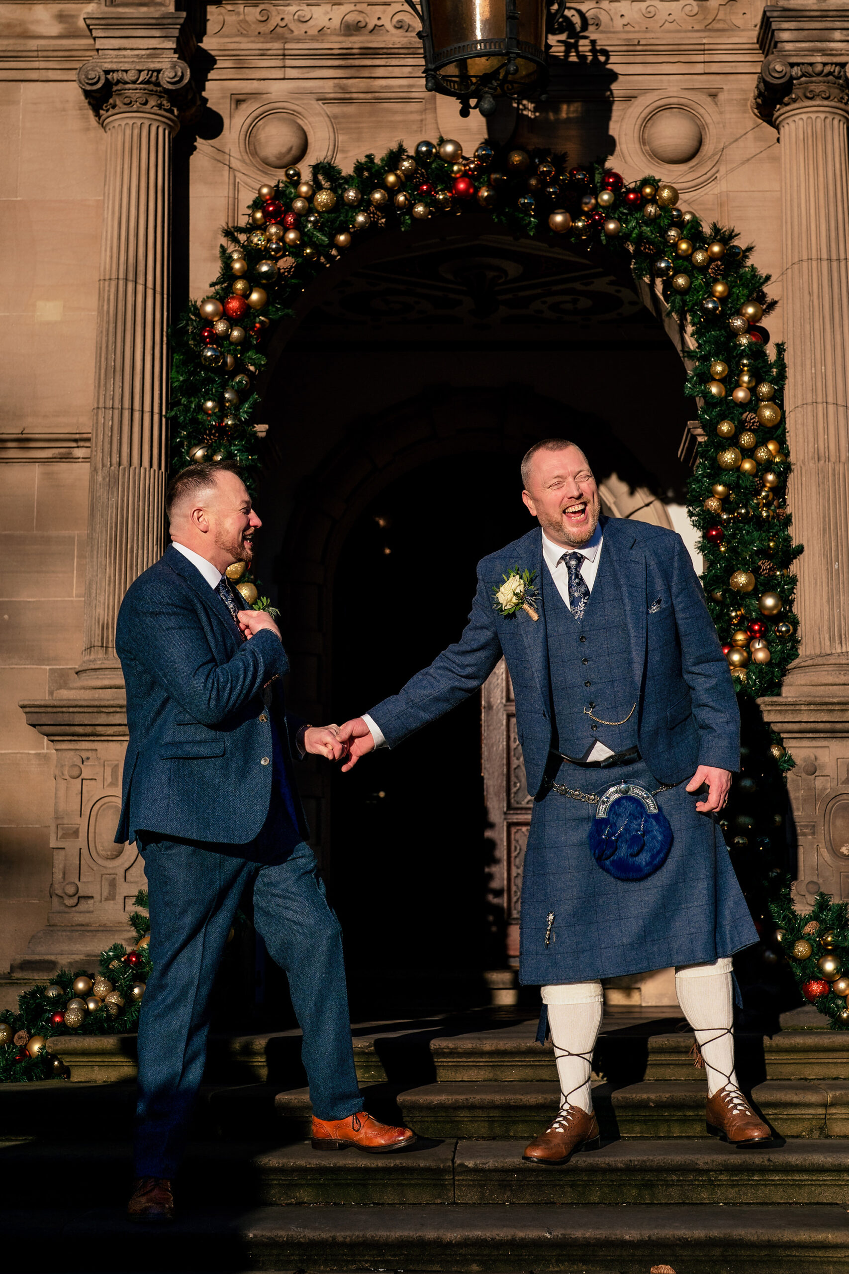 A warm handshake at the entrance archway to Crewe Hall