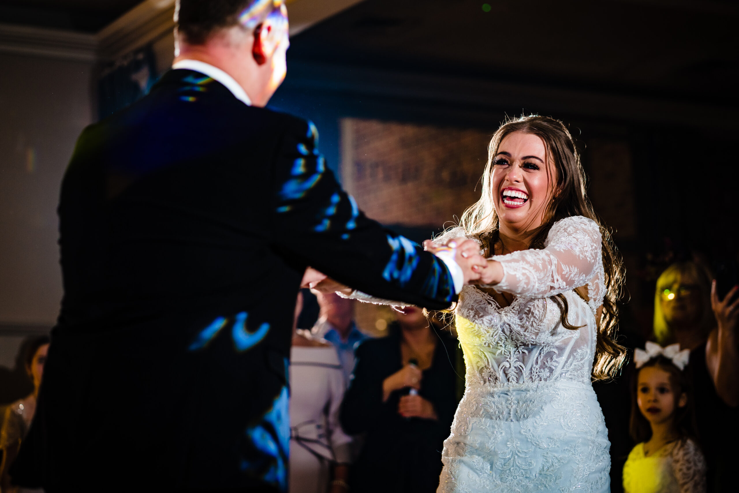 Abbie laughing as she dances with her dad before the first dance at Merrydale Manor