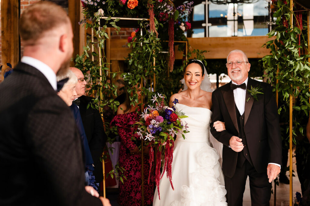Kim and her dad arriving at the front of the glass barn, Glynn in the foreground, Nottingham wedding photographer