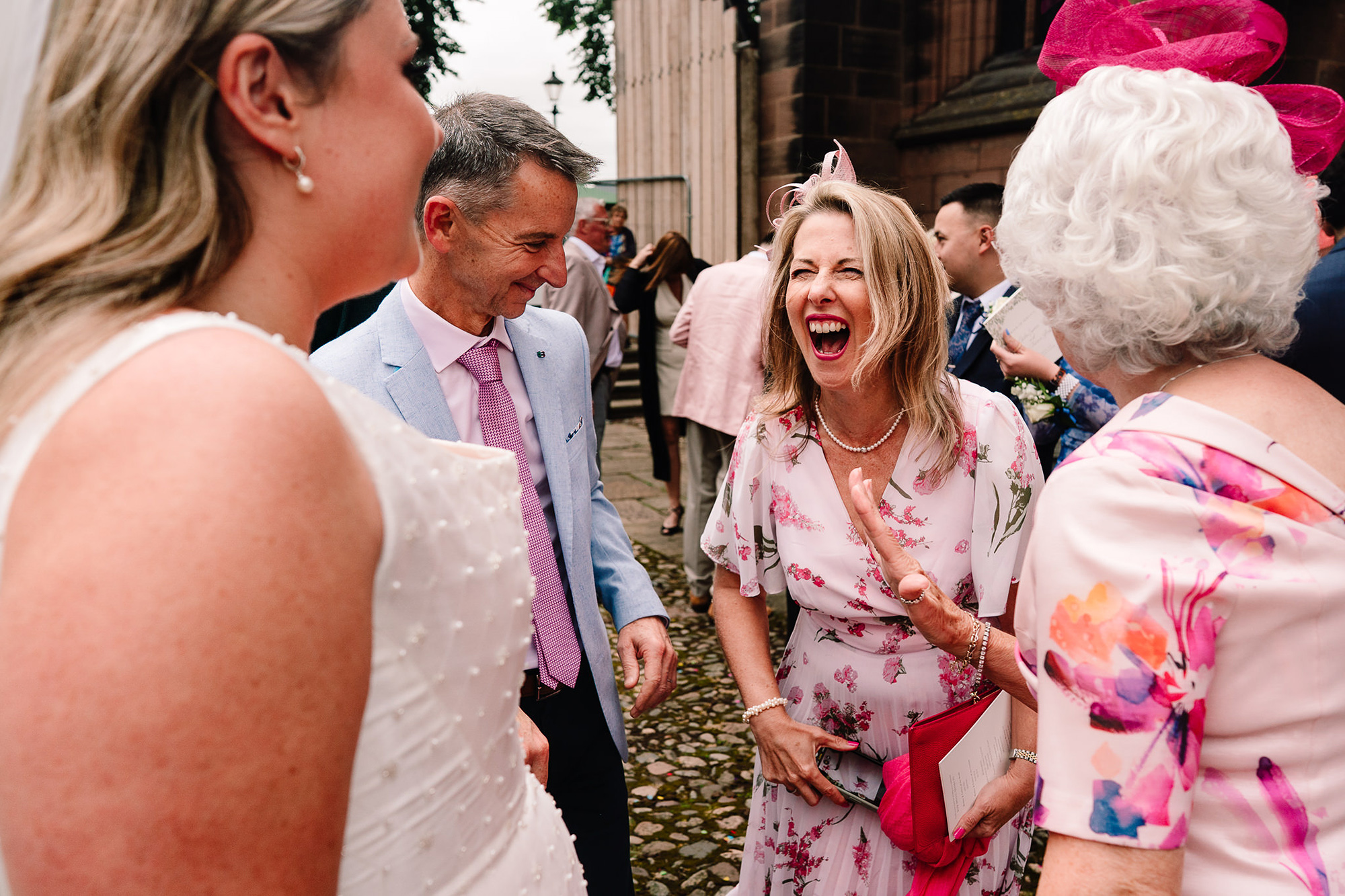 A candid greeting between guests outside St Mary’s Church after the ceremony