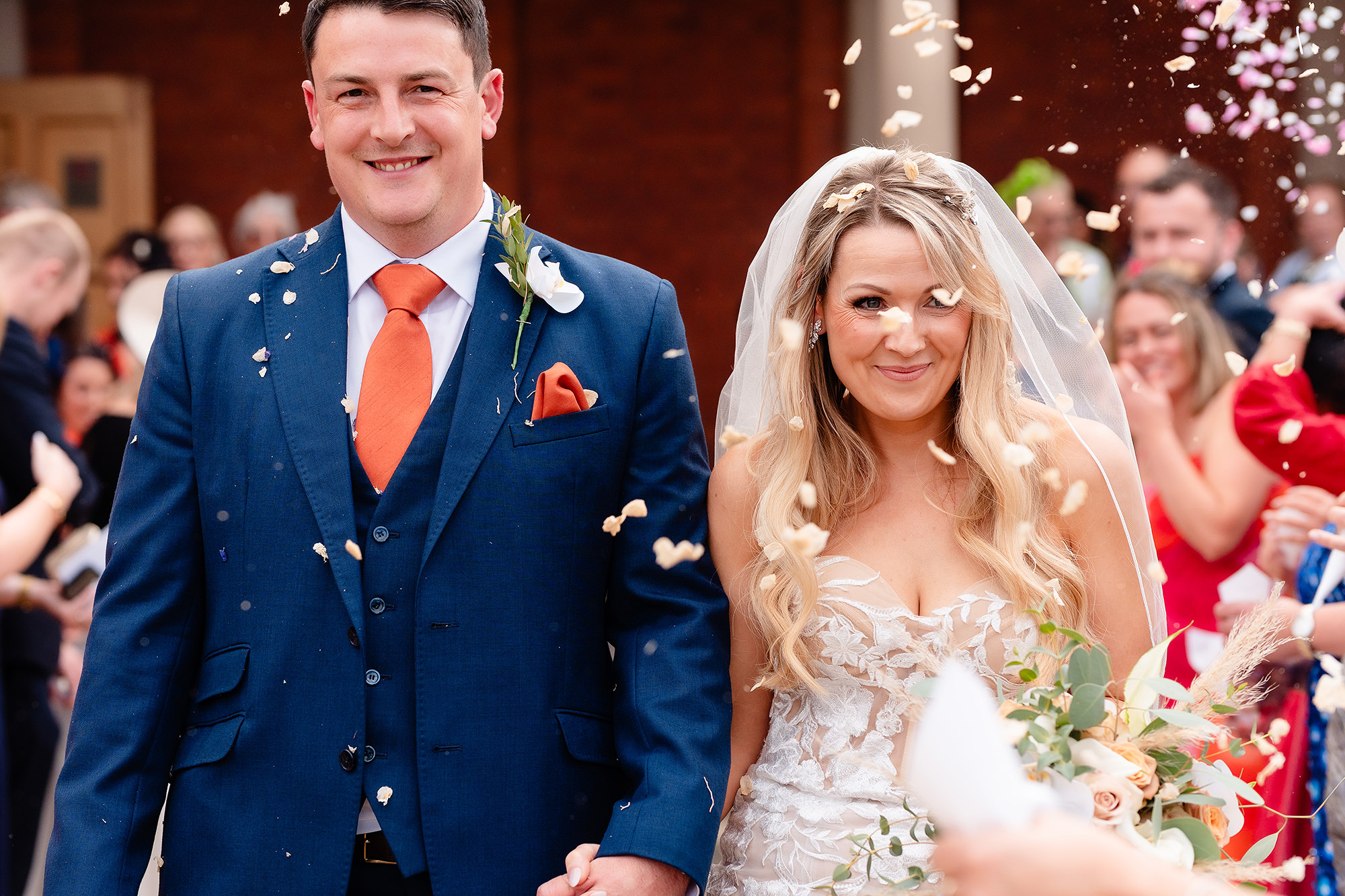 Close up of the bride and groom laughing as confetti falls around them, Crewe Hall wedding photographer