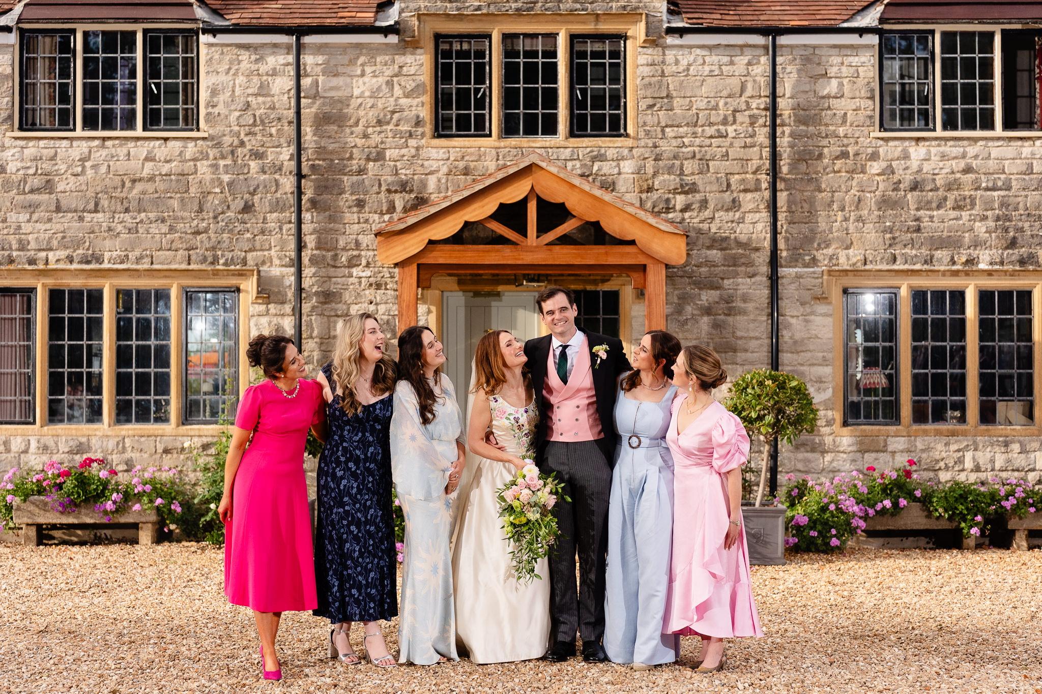 Bride surrounded by her bridesmaids in the afternoon sunshine