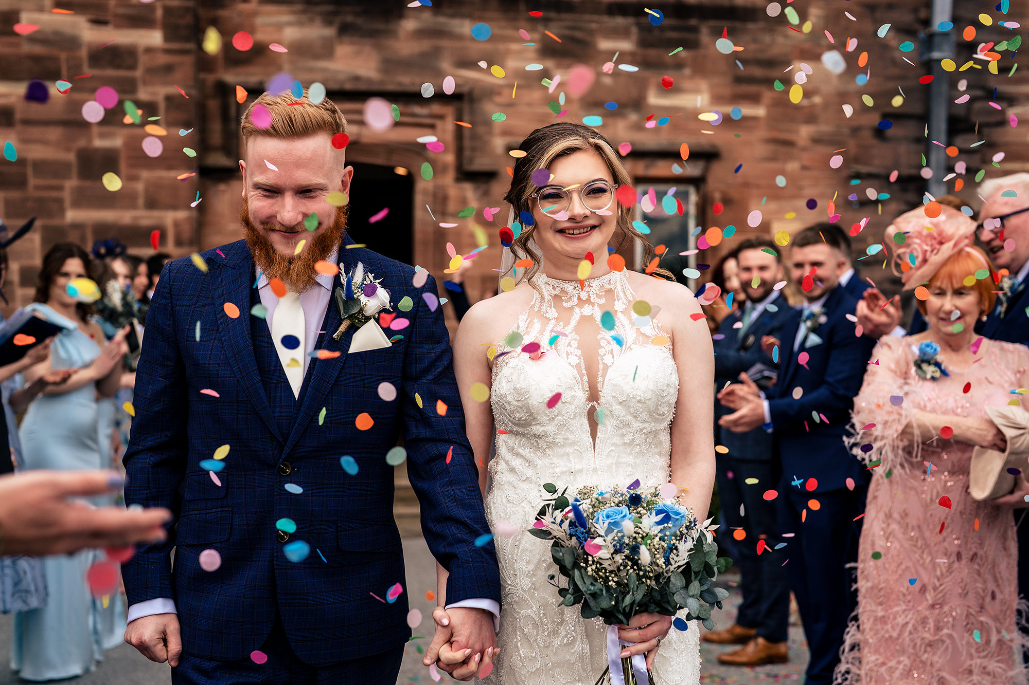Confetti falling around the newlyweds as guests cheer, Salt House wedding photographer