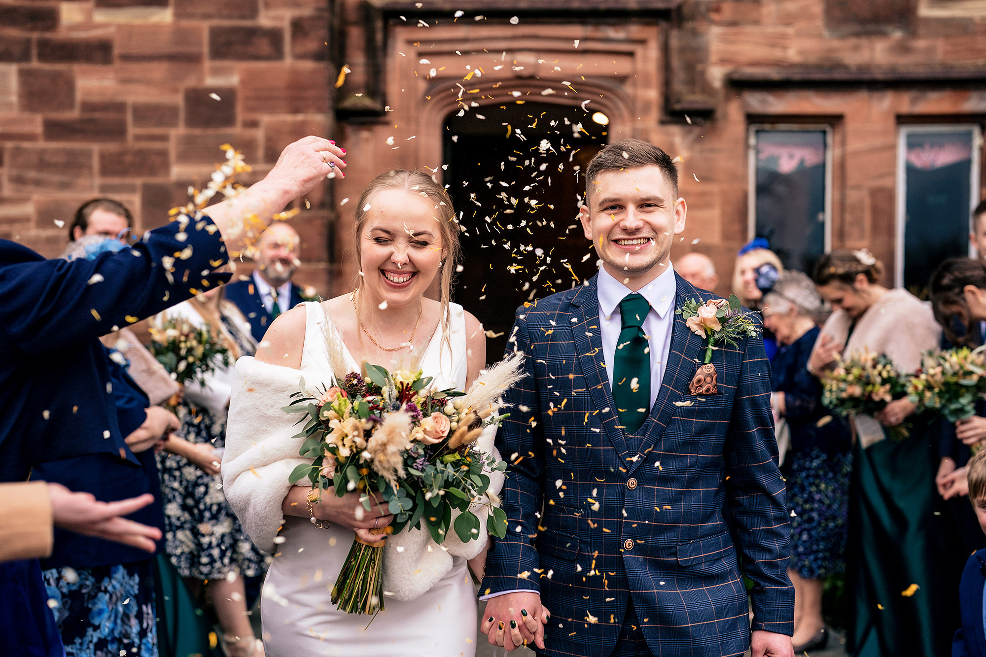 Chloe and Dan laughing together in the middle of their confetti exit
