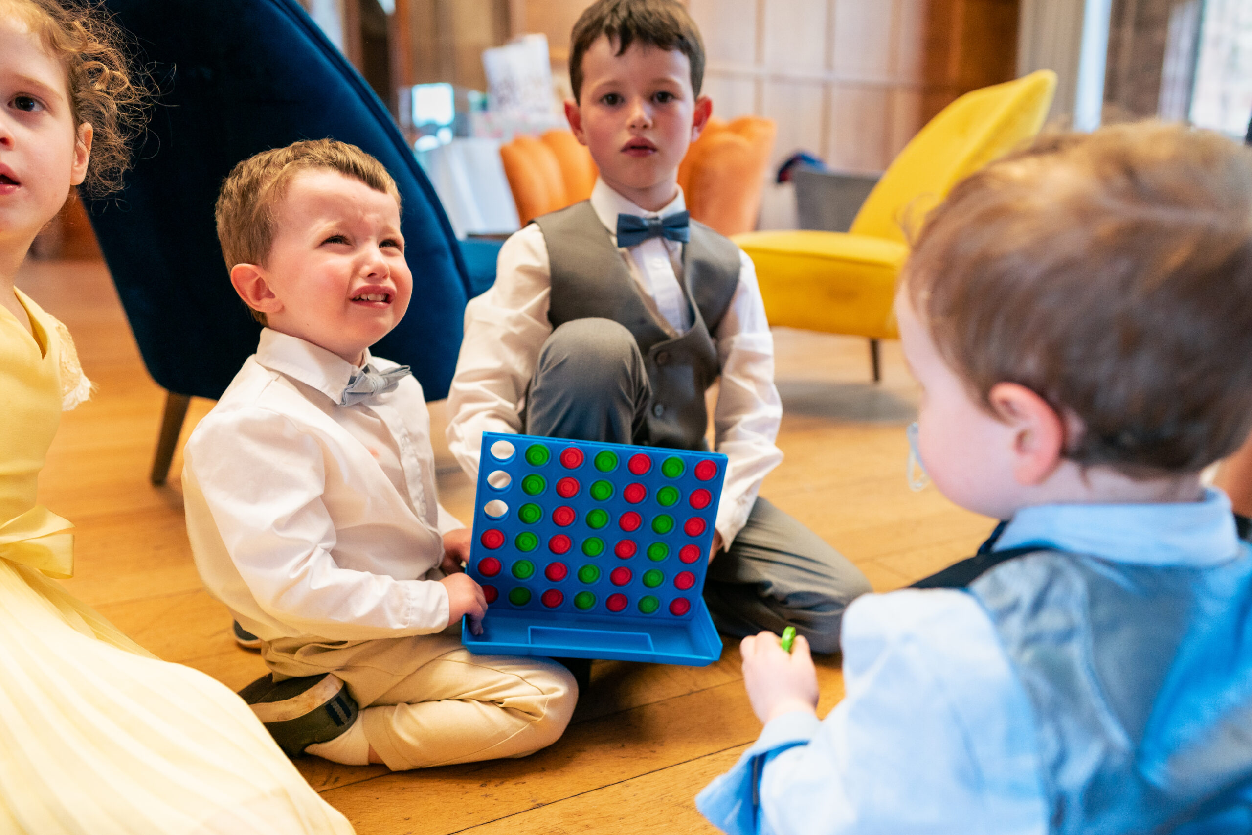 Children playing a game together indoors at Salt House during the wedding breakfast
